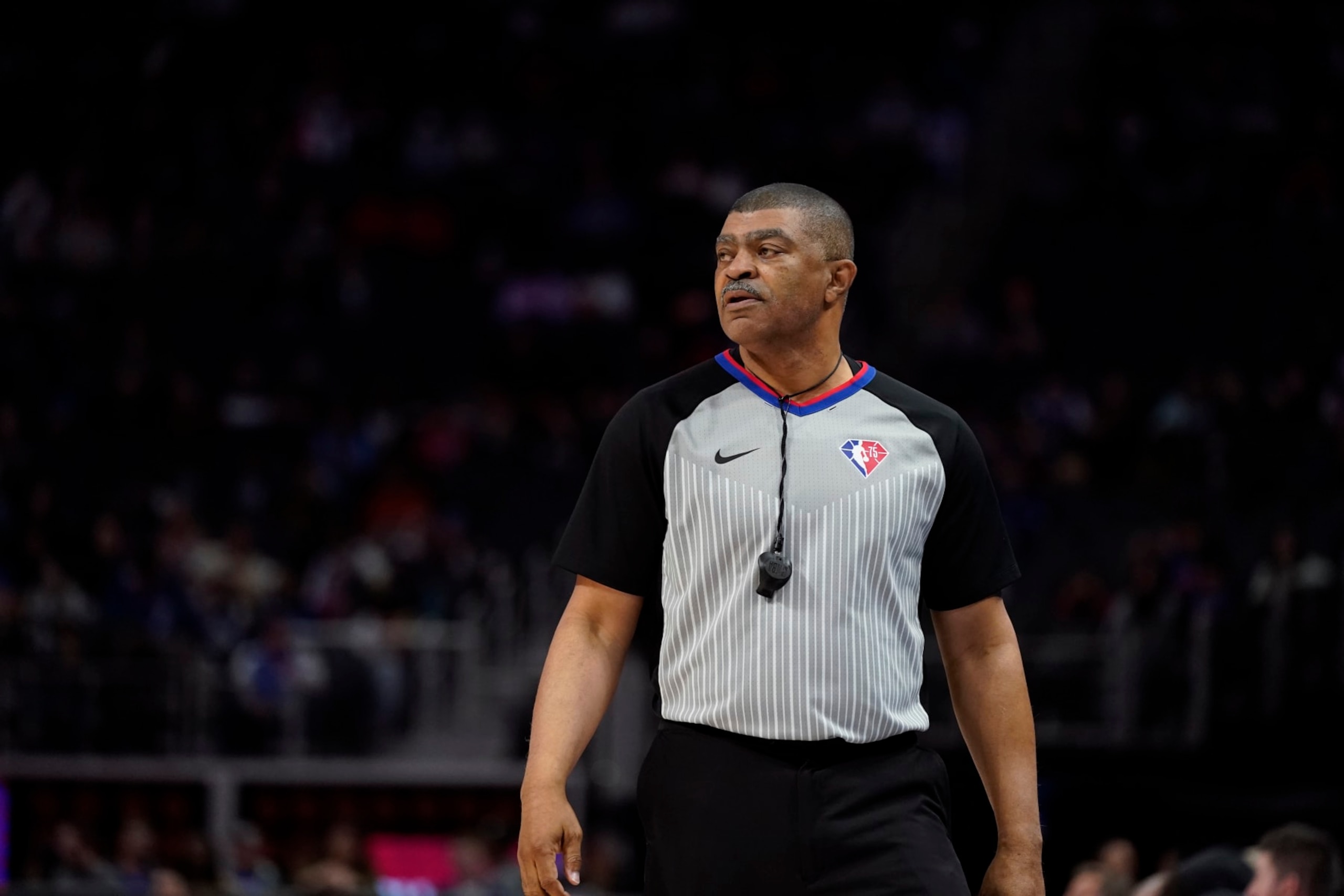 Referee Tony Brothers observes during the first half of an NBA basketball game between the Detroit Pistons and the Washington Wizards, Friday, March 25, 2022, in Detroit. (AP Photo/Carlos Osorio)