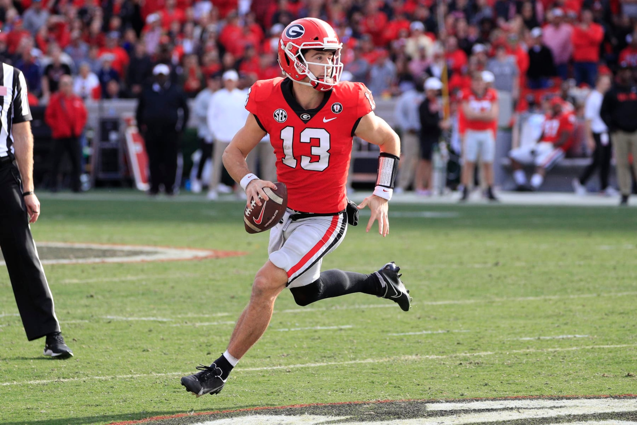 ATHENS, GA - NOVEMBER 26: Georgia Bulldogs starting quarterback Stetson Bennett (13) rolls out during second half of the Saturday afternoon college football game between the University of Georgia Bulldogs and the Georgia Tech Yellow Jackets on November 26, 2022 at Sanford Stadium in Athens, GA.  (Photo by David J. Griffin/Icon Sportswire via Getty Images)