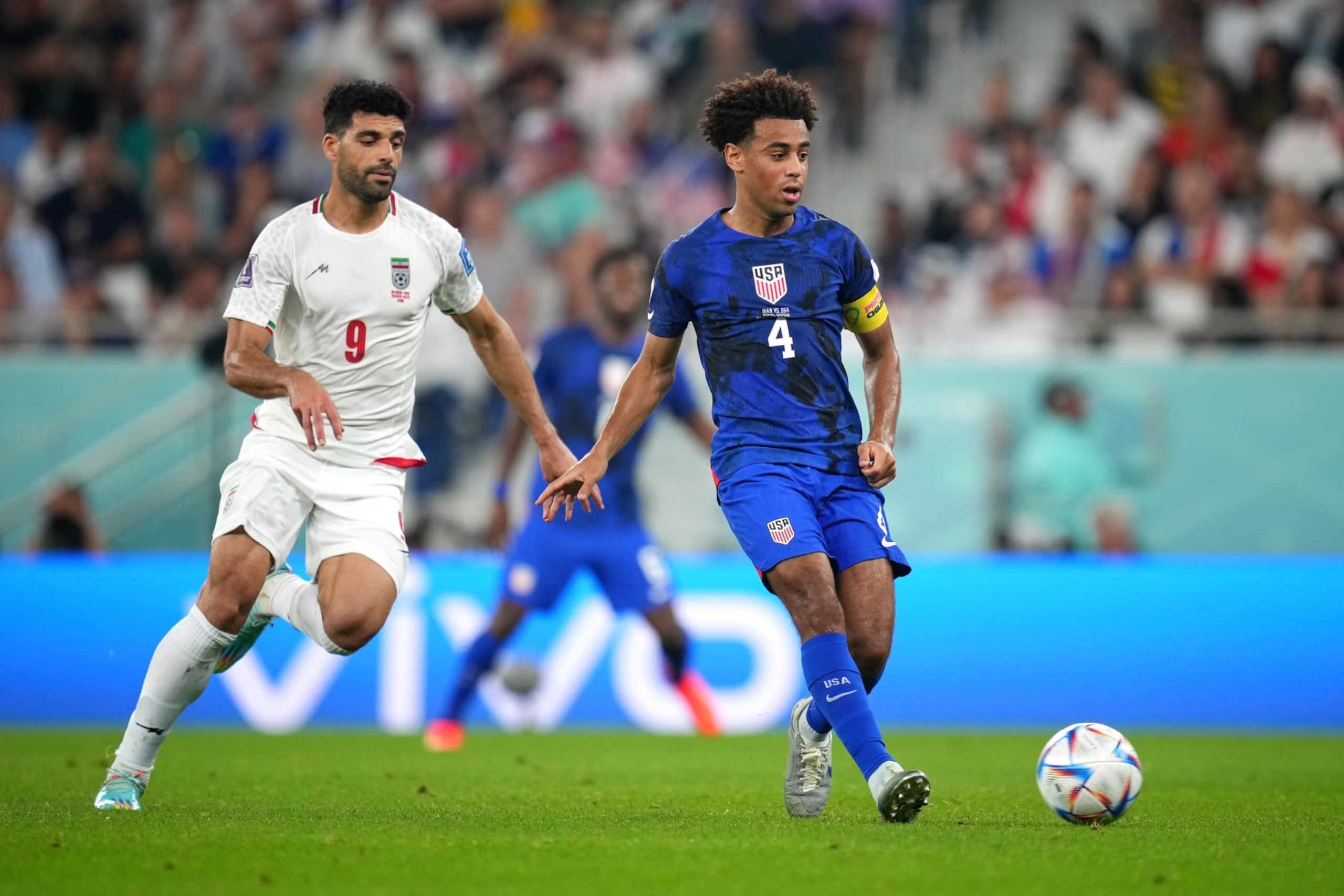 DOHA, QATAR - NOVEMBER 29: Tyler Adams of United States controls the ball from Mehdi Taremi of IR Iran during the FIFA World Cup Qatar 2022 Group B match between IR Iran and USA at Al Thumama Stadium on November 29, 2022 in Doha, Qatar. (Photo by Alex Caparros - FIFA/FIFA via Getty Images)