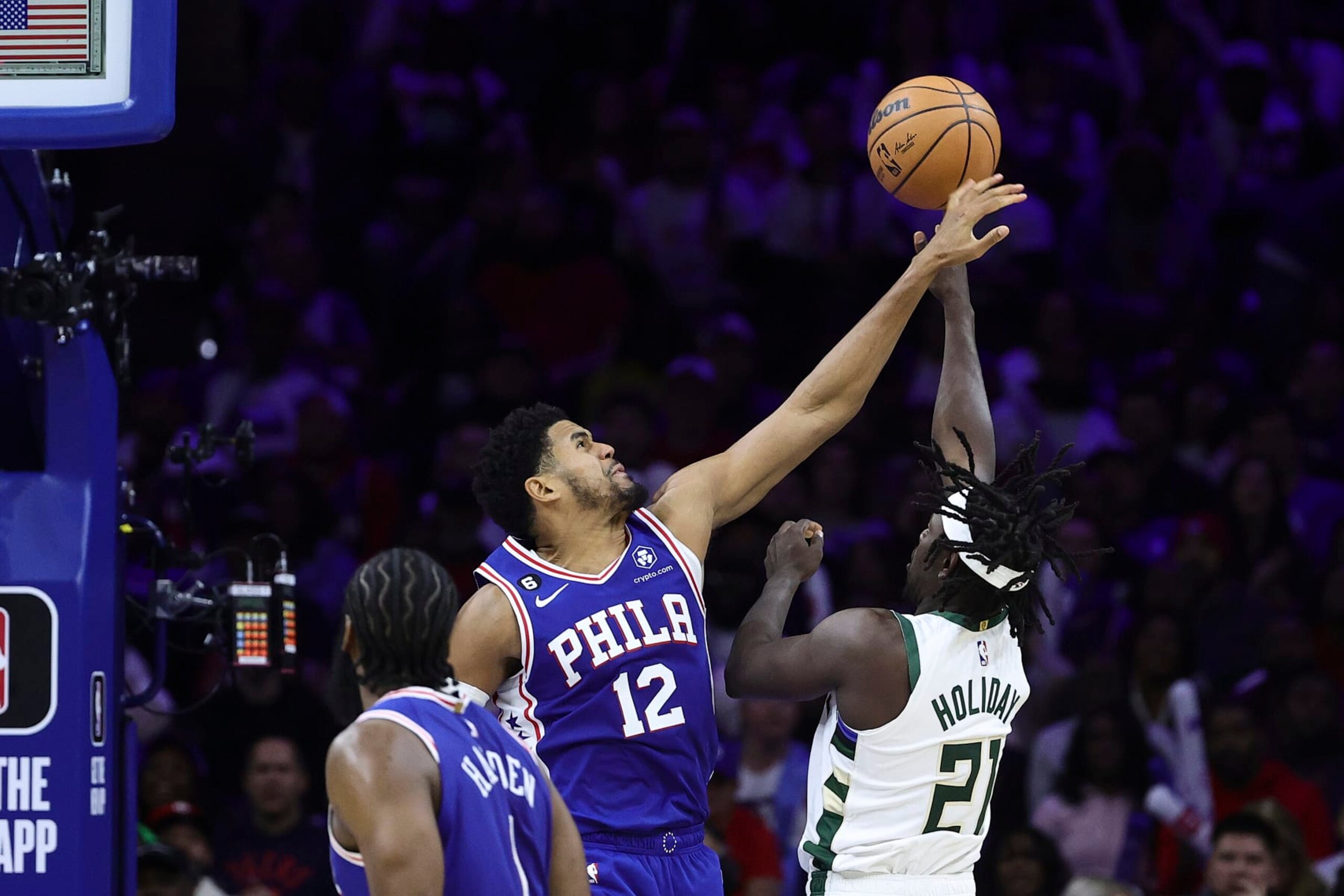 PHILADELPHIA, PENNSYLVANIA - OCTOBER 20: Tobias Harris #12 of the Philadelphia 76ers blocks Jrue Holiday #21 of the Milwaukee Bucks during the fourth quarter at Wells Fargo Center on October 20, 2022 in Philadelphia, Pennsylvania. NOTE TO USER: User expressly acknowledges and agrees that, by downloading and or using this photograph, User is consenting to the terms and conditions of the Getty Images License Agreement. (Photo by Tim Nwachukwu/Getty Images)