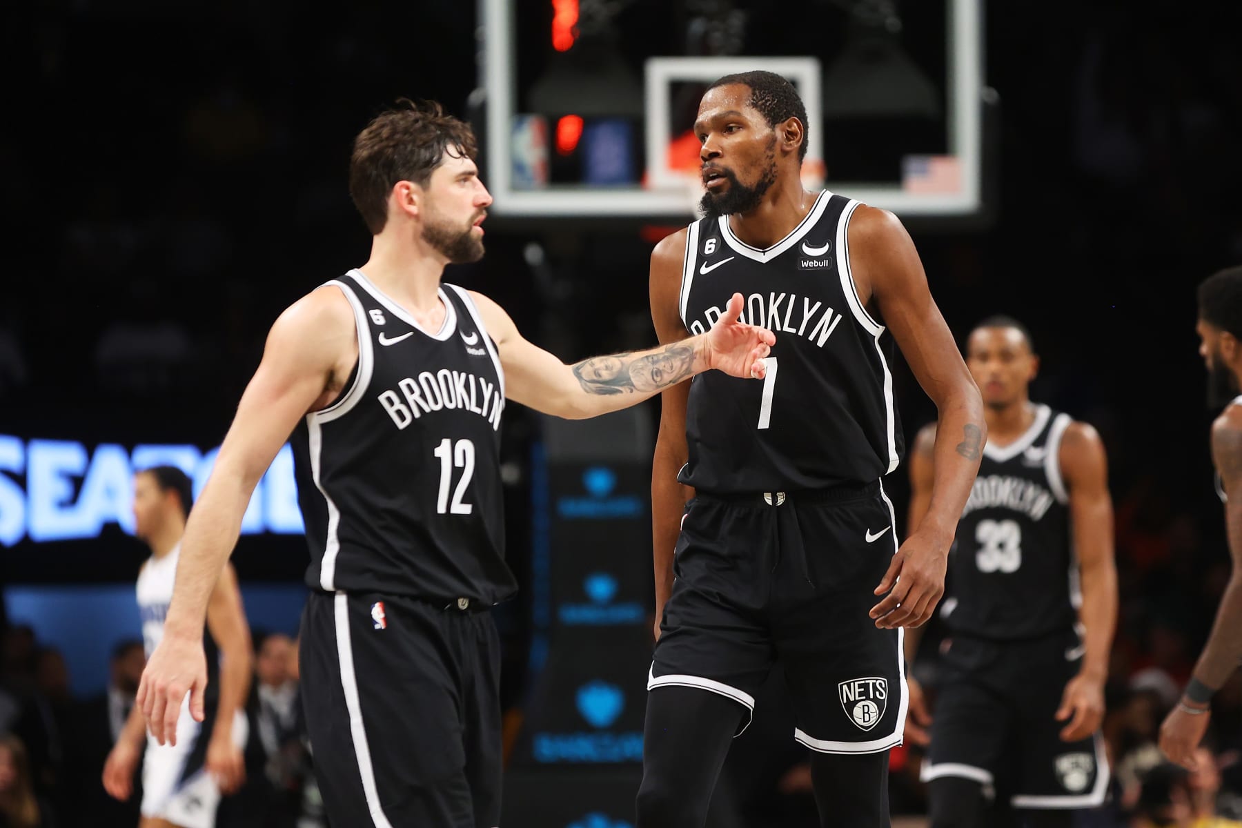 NEW YORK, NEW YORK - NOVEMBER 28: Kevin Durant #7 and Joe Harris #12 of the Brooklyn Nets in action against the Orlando Magic at Barclays Center on November 28, 2022 in New York City. NOTE TO USER: User expressly acknowledges and agrees that, by downloading and or using this Photograph, user is consenting to the terms and conditions of the Getty Images License Agreement. Brooklyn Nets defeated the Orlando Magic 109-102. (Photo by Mike Stobe/Getty Images)