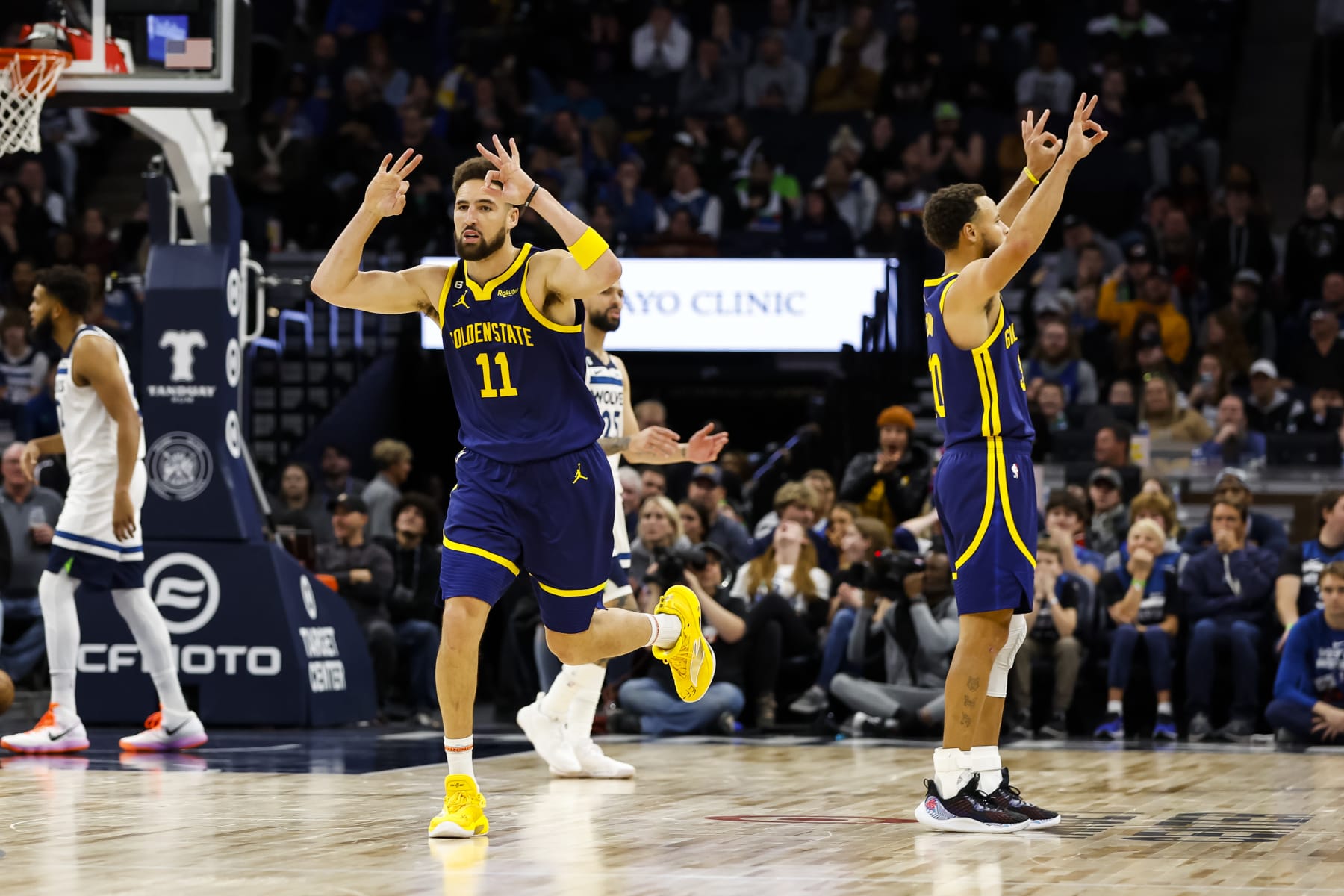 MINNEAPOLIS, MN - NOVEMBER 27: Klay Thompson #11 and Stephen Curry #30 of the Golden State Warriors celebrate a three-point basket by Thompson against the Minnesota Timberwolves in the fourth quarter at Target Center on November 27, 2022 in Minneapolis, Minnesota. The Warriors defeated the Timberwolves 137-114. NOTE TO USER: User expressly acknowledges and agrees that, by downloading and or using this Photograph, user is consenting to the terms and conditions of the Getty Images License Agreement. (Photo by David Berding/Getty Images)