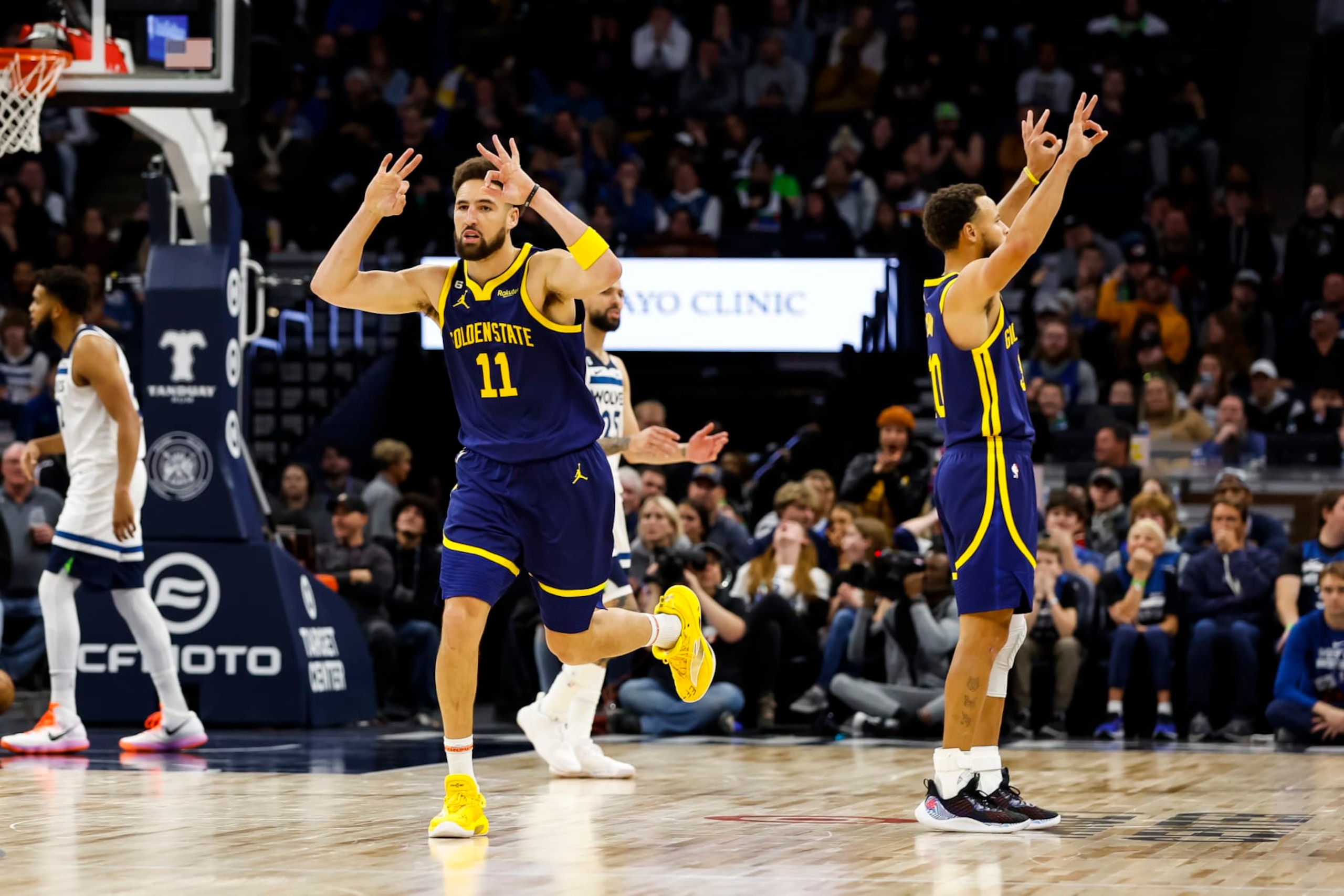 MINNEAPOLIS, MN - NOVEMBER 27: Klay Thompson #11 and Stephen Curry #30 of the Golden State Warriors celebrate a three-point basket by Thompson against the Minnesota Timberwolves in the fourth quarter at Target Center on November 27, 2022 in Minneapolis, Minnesota. The Warriors defeated the Timberwolves 137-114. NOTE TO USER: User expressly acknowledges and agrees that, by downloading and or using this Photograph, user is consenting to the terms and conditions of the Getty Images License Agreement. (Photo by David Berding/Getty Images)