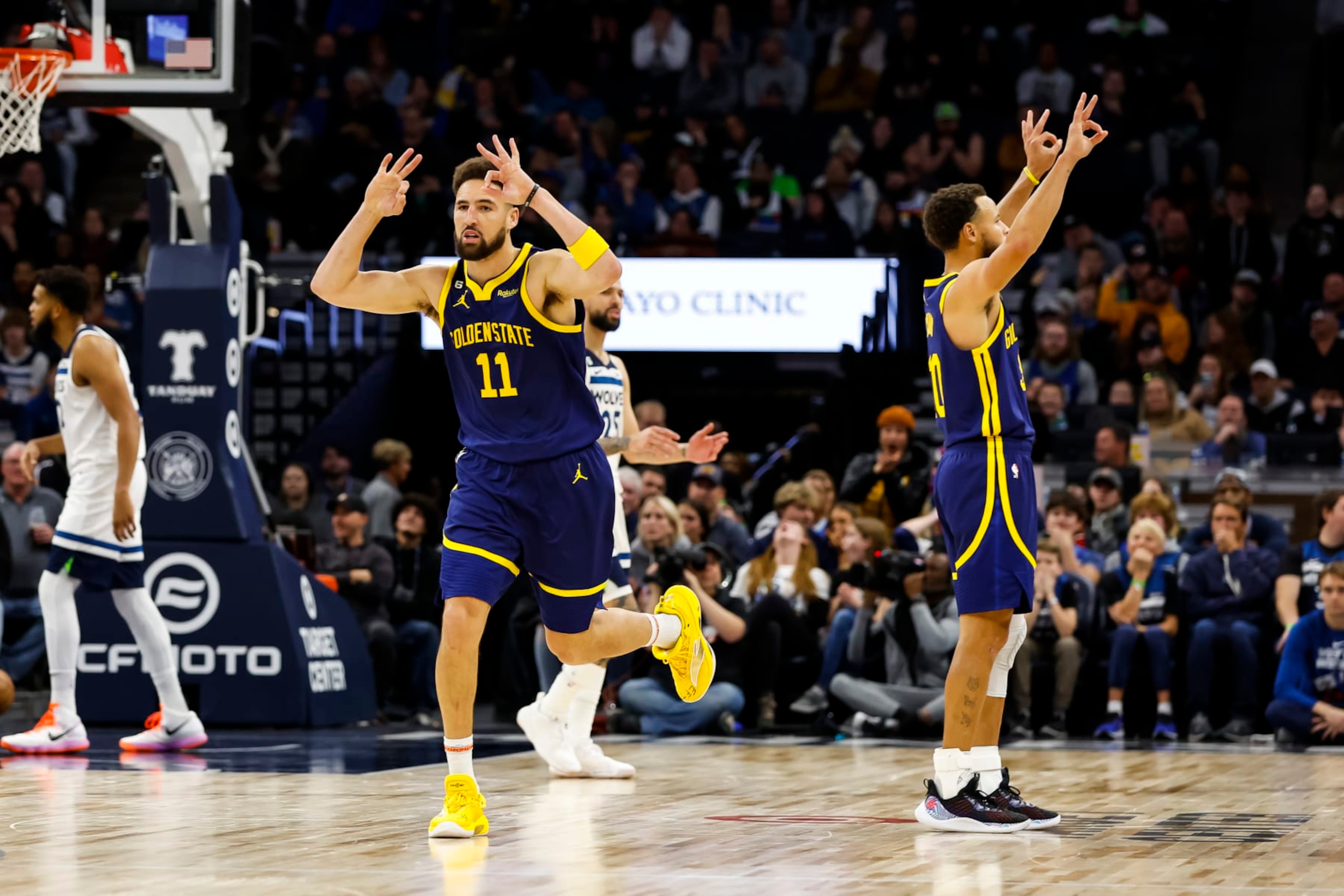 MINNEAPOLIS, MN - NOVEMBER 27: Klay Thompson #11 and Stephen Curry #30 of the Golden State Warriors celebrate a three-point basket by Thompson against the Minnesota Timberwolves in the fourth quarter at Target Center on November 27, 2022 in Minneapolis, Minnesota. The Warriors defeated the Timberwolves 137-114. NOTE TO USER: User expressly acknowledges and agrees that, by downloading and or using this Photograph, user is consenting to the terms and conditions of the Getty Images License Agreement. (Photo by David Berding/Getty Images)