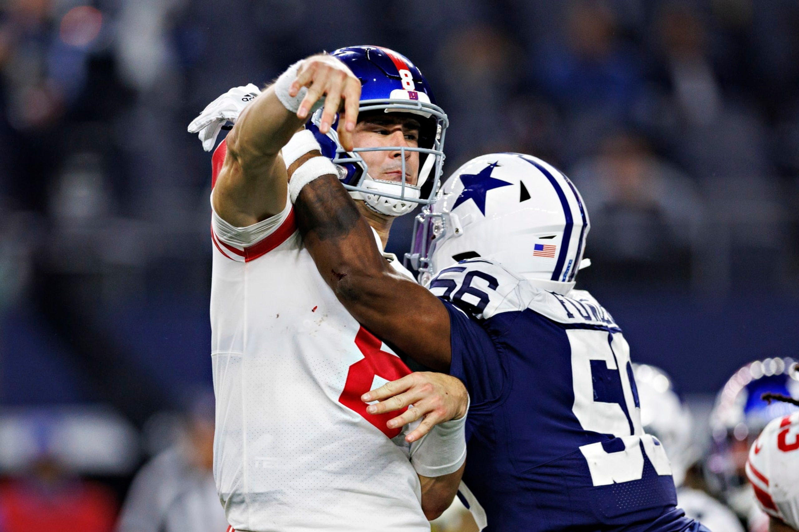ARLINGTON, TEXAS - NOVEMBER 24: Daniel Jones #8 of the New York Giants throws a pass under pressure from Dante Fowler #56 of the Dallas Cowboys at AT&T Stadium on November 24, 2022 in Arlington, Texas. The Cowboys defeated the Giants 28-20. (Photo by Wesley Hitt/Getty Images) ARLINGTON, TEXAS - NOVEMBER 24: Daniel Jones #8 of the New York Giants throws a pass under pressure from Dante Fowler #56 of the Dallas Cowboys at AT&T Stadium on November 24, 2022 in Arlington, Texas. The Cowboys defeated the Giants 28-20. (Photo by Wesley Hitt/Getty Images)
