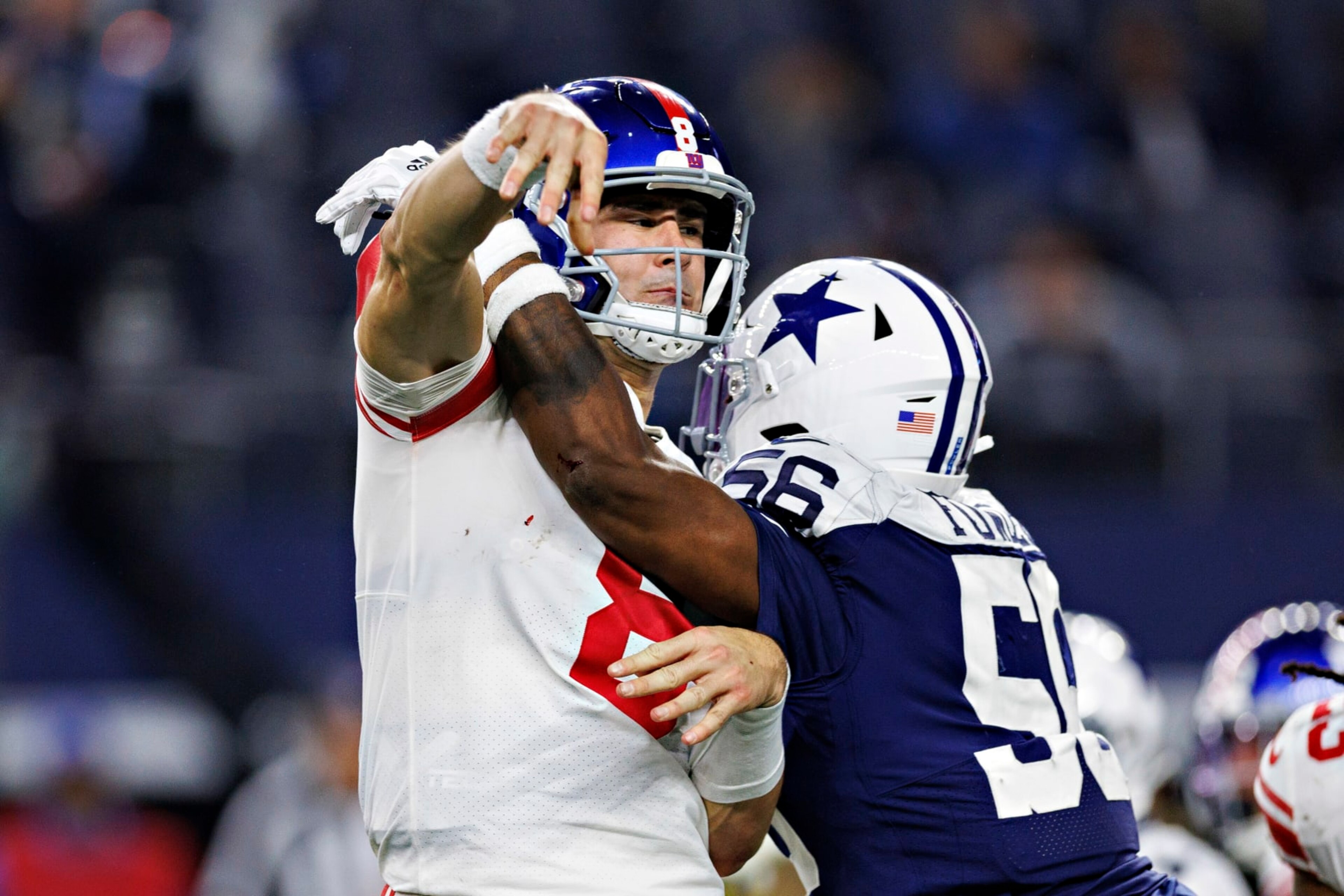 ARLINGTON, TEXAS - NOVEMBER 24: Daniel Jones #8 of the New York Giants throws a pass under pressure from Dante Fowler #56 of the Dallas Cowboys at AT&T Stadium on November 24, 2022 in Arlington, Texas. The Cowboys defeated the Giants 28-20. (Photo by Wesley Hitt/Getty Images) ARLINGTON, TEXAS - NOVEMBER 24: Daniel Jones #8 of the New York Giants throws a pass under pressure from Dante Fowler #56 of the Dallas Cowboys at AT&T Stadium on November 24, 2022 in Arlington, Texas. The Cowboys defeated the Giants 28-20. (Photo by Wesley Hitt/Getty Images)