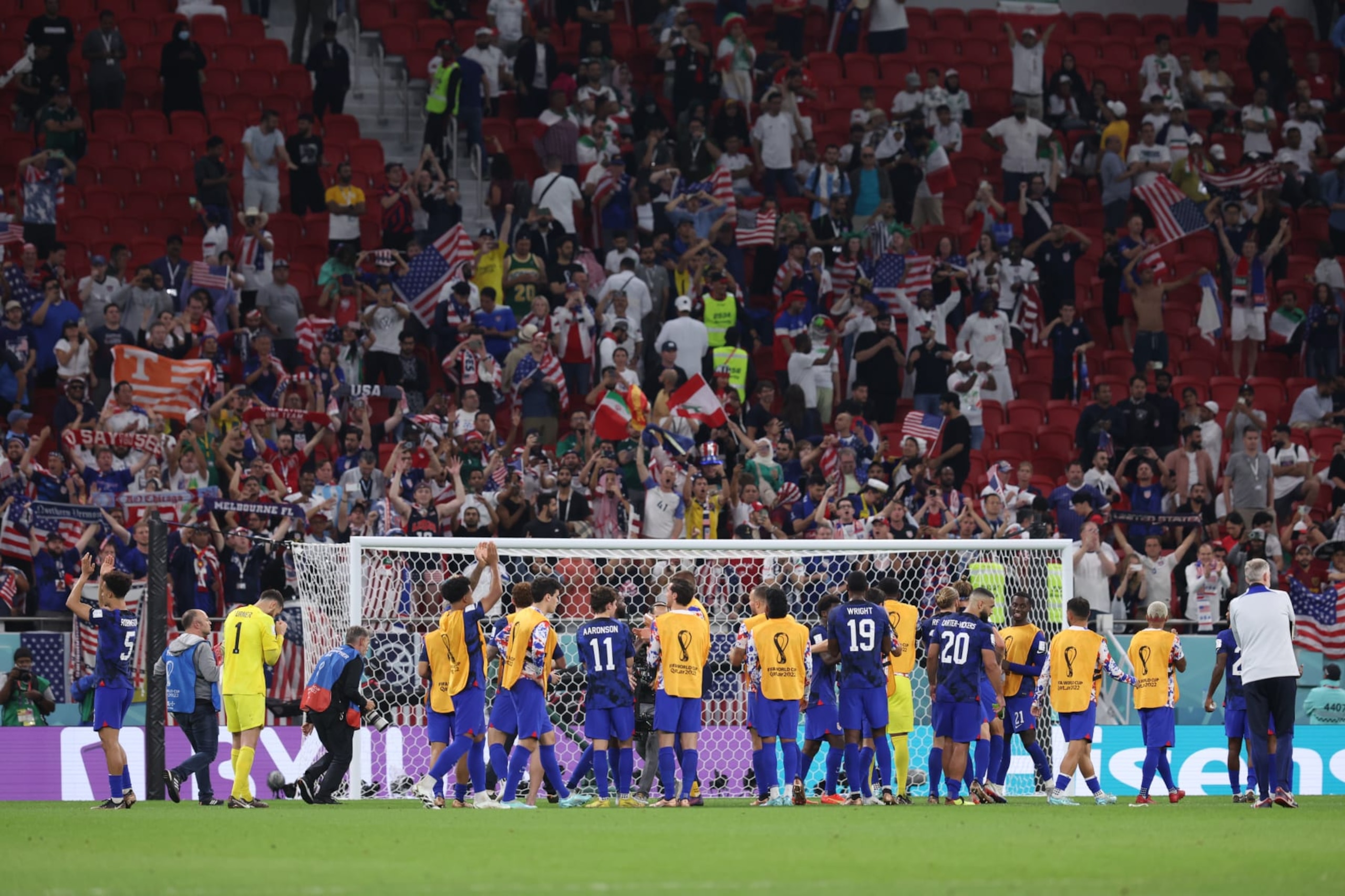 USMNT celebrate their 1-0 victory over Iran, officially qualifying them for the next round of the World Cup.
