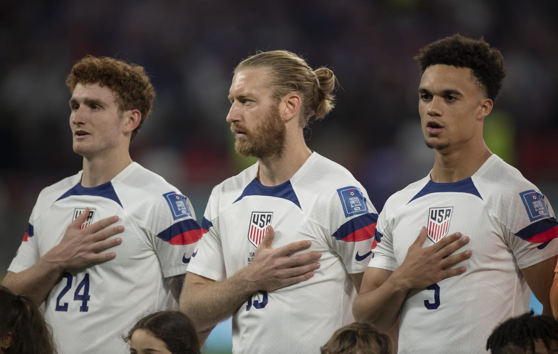 DOHA, QATAR - NOVEMBER 21: Josh Sargent, Tim Ream and Antonee Robinson of USA sing the national anthem before the FIFA World Cup Qatar 2022 Group B match between USA and Wales at Ahmad Bin Ali Stadium on November 21, 2022 in Doha, Qatar. (Photo by Visionhaus/Getty Images)