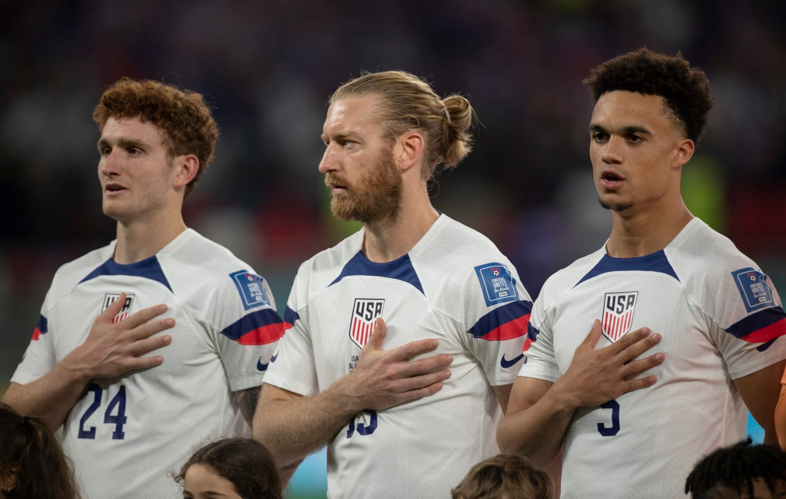 DOHA, QATAR - NOVEMBER 21: Josh Sargent, Tim Ream and Antonee Robinson of USA sing the national anthem before the FIFA World Cup Qatar 2022 Group B match between USA and Wales at Ahmad Bin Ali Stadium on November 21, 2022 in Doha, Qatar. (Photo by Visionhaus/Getty Images)