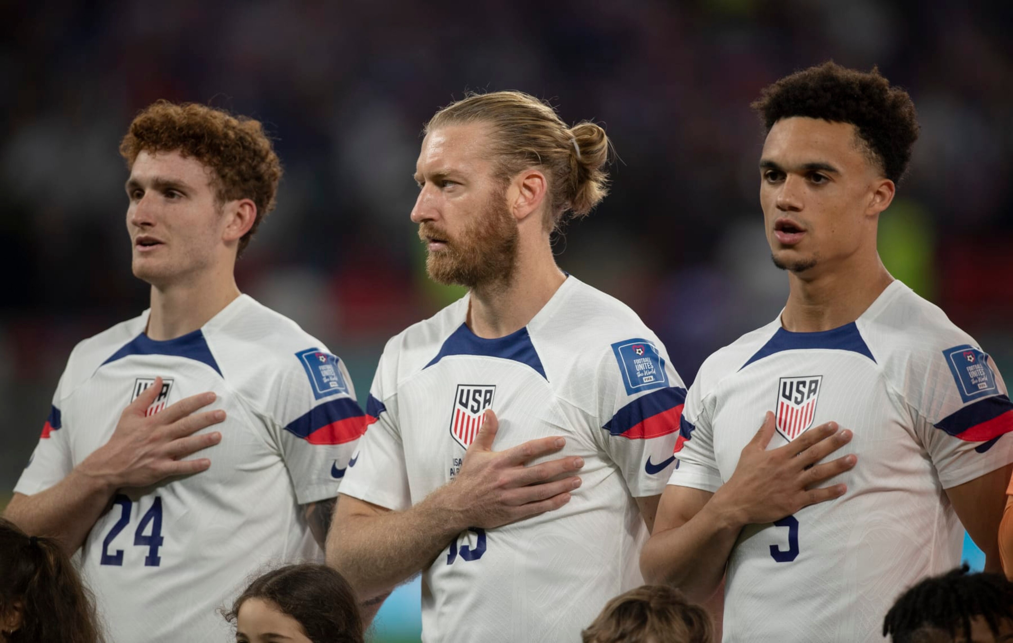 DOHA, QATAR - NOVEMBER 21: Josh Sargent, Tim Ream and Antonee Robinson of USA sing the national anthem before the FIFA World Cup Qatar 2022 Group B match between USA and Wales at Ahmad Bin Ali Stadium on November 21, 2022 in Doha, Qatar. (Photo by Visionhaus/Getty Images)