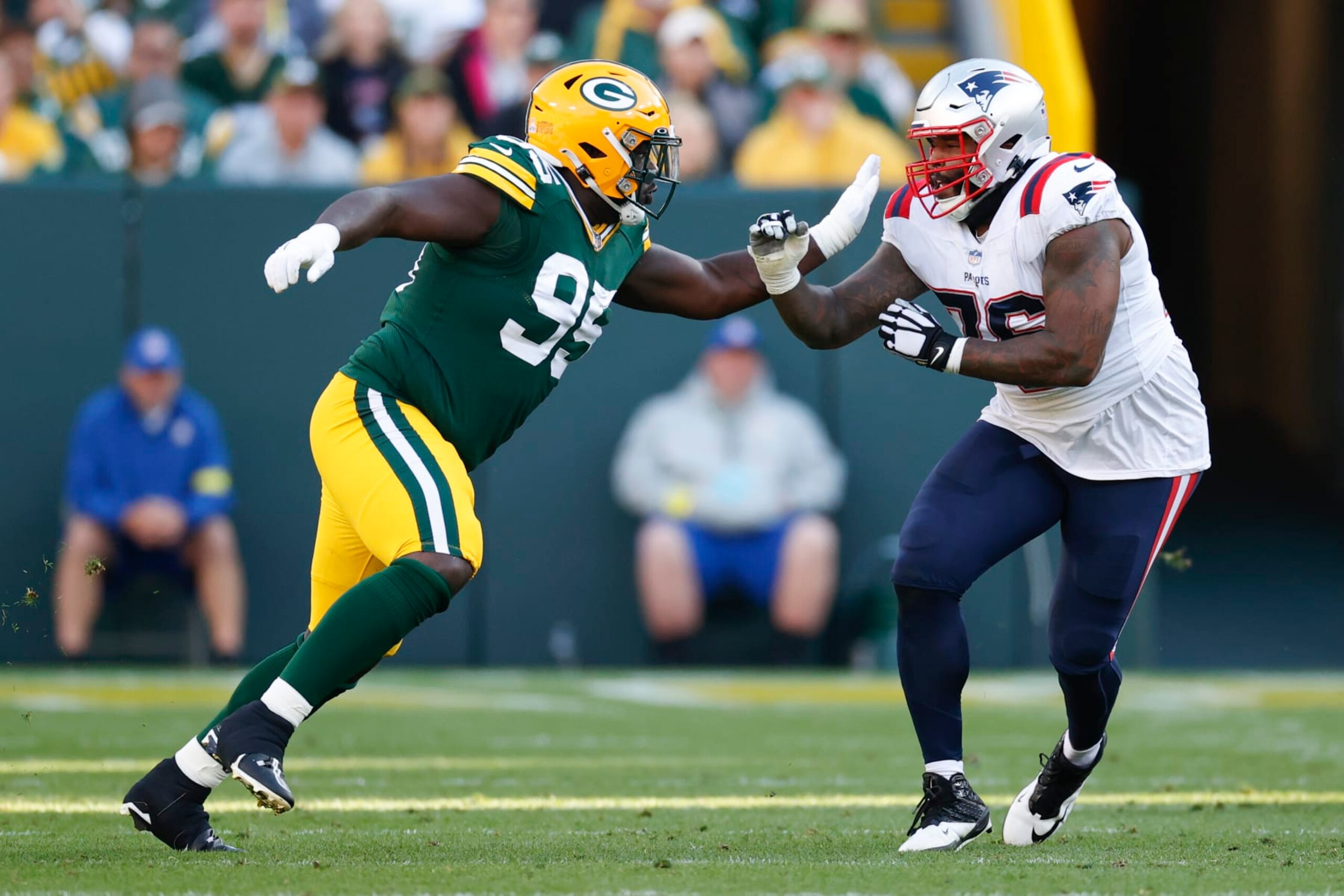 Green Bay Packers defensive tackle Devonte Wyatt (95) battles for the position with New England Patriots offensive tackle Isaiah Wynn (76) during the first half of an NFL football game, Sunday, Oct. 2, 2022, in Green Bay, Wis. (AP Photo/Kamil Krzaczynski)