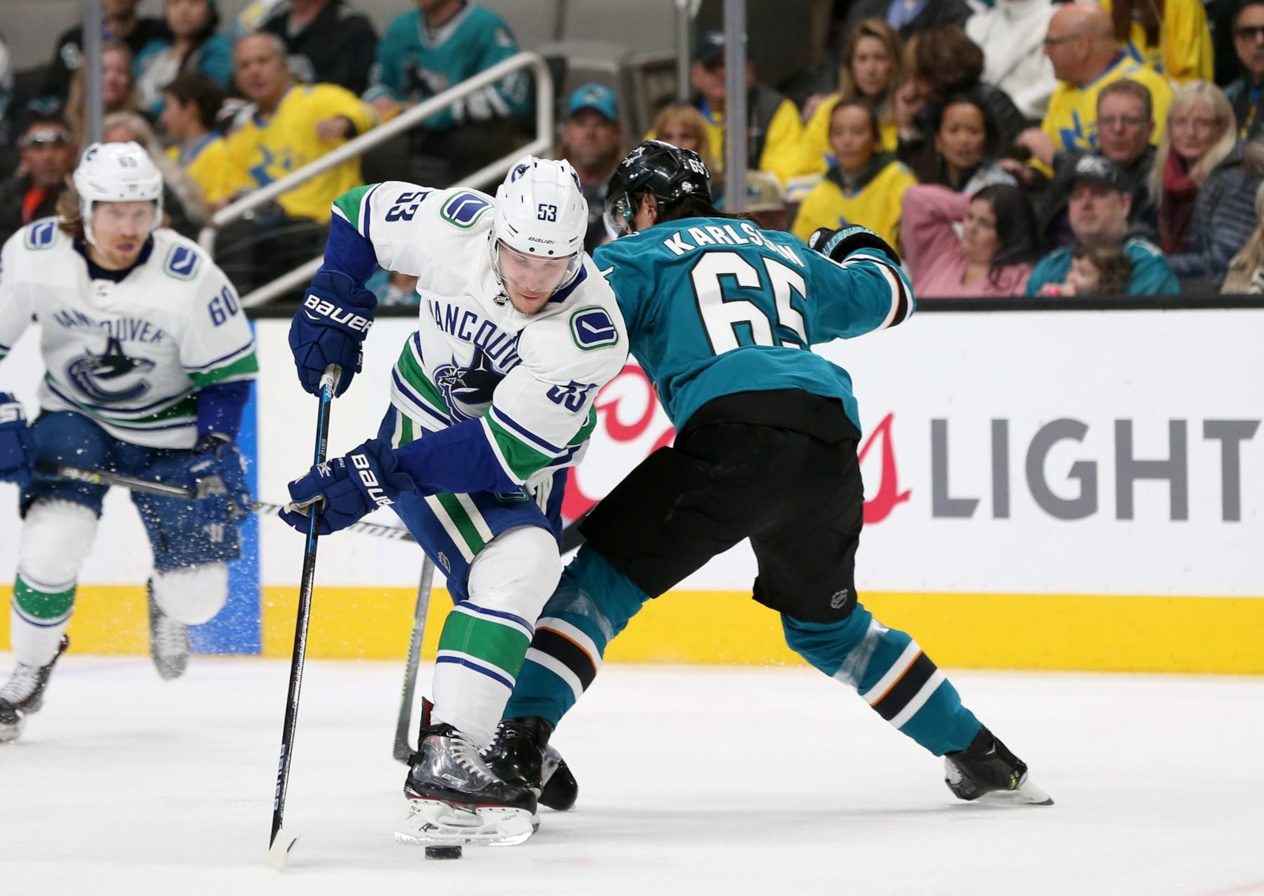 Vancouver Canucks center Bo Horvat (left) attempts to skate around San Jose Sharks defenseman Erik Karlsson.