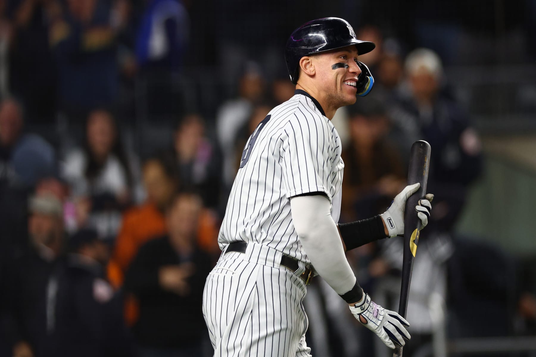 NEW YORK, NEW YORK - OCTOBER 23: Aaron Judge #99 of the New York Yankees smiles after a solo home run by Harrison Bader #22 in the sixth inning against the Houston Astros in game four of the American League Championship Series at Yankee Stadium on October 23, 2022 in the Bronx borough of New York City. (Photo by Elsa/Getty Images)