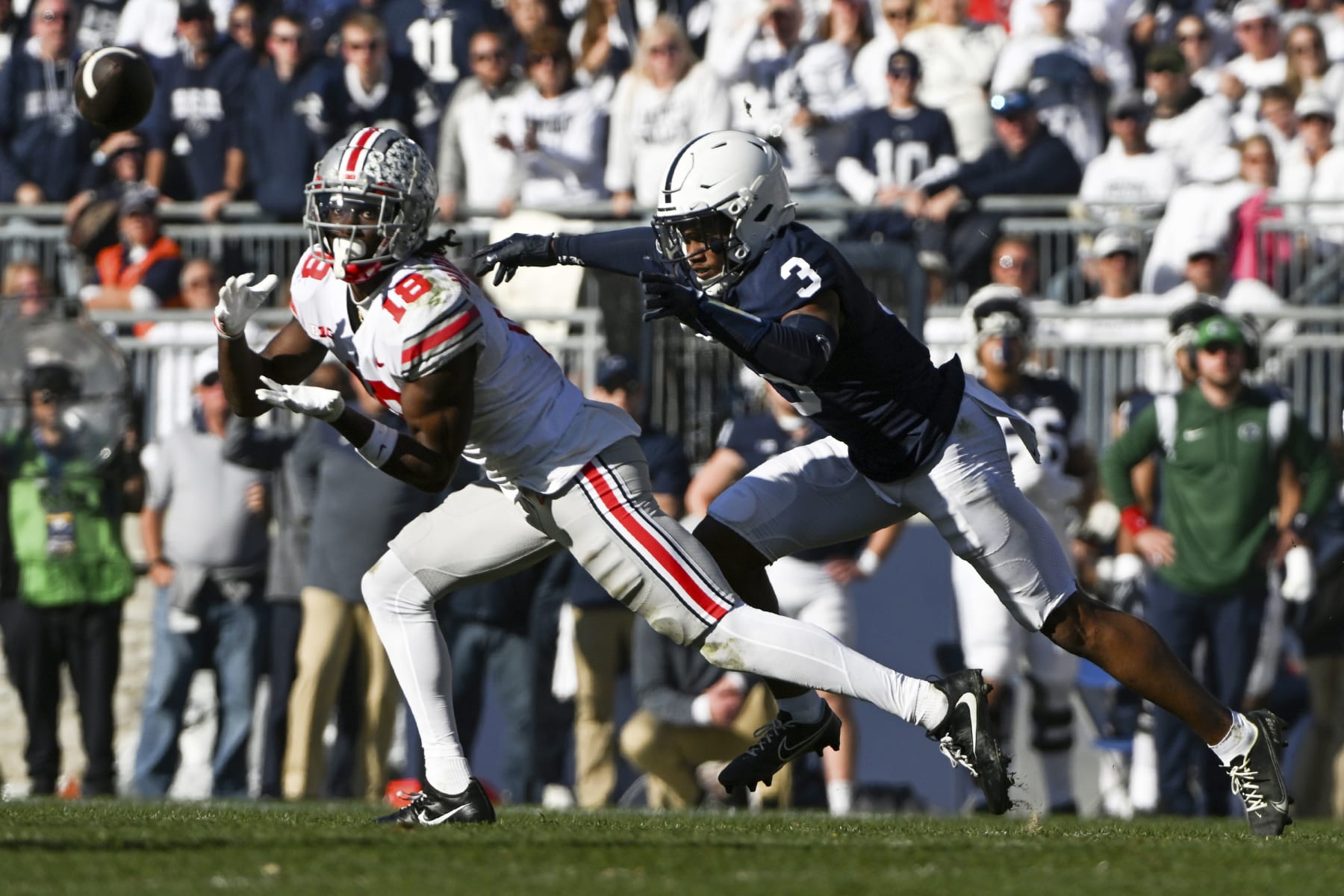 Ohio State wide receiver Marvin Harrison Jr. (18) makes a catch in front of Penn State cornerback Johnny Dixon (3) during the second half of an NCAA college football game, Saturday, Oct. 29, 2022, in State College, Pa. (AP Photo/Barry Reeger)