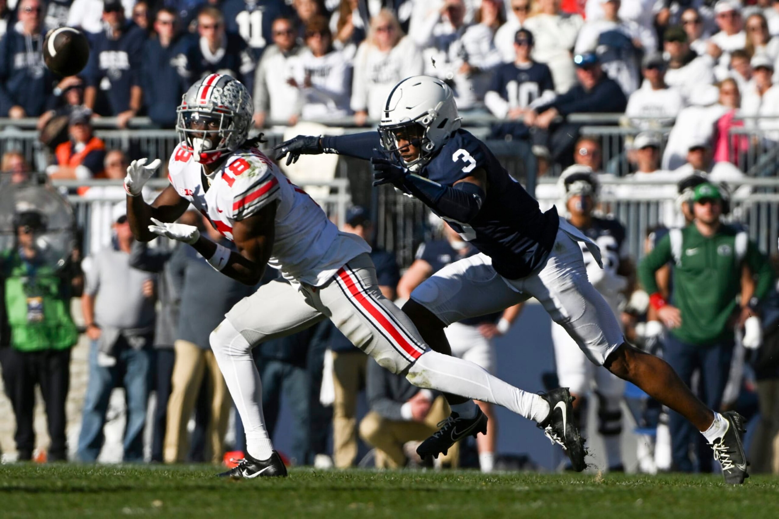 Ohio State wide receiver Marvin Harrison Jr. (18) makes a catch in front of Penn State cornerback Johnny Dixon (3) during the second half of an NCAA college football game, Saturday, Oct. 29, 2022, in State College, Pa. (AP Photo/Barry Reeger)