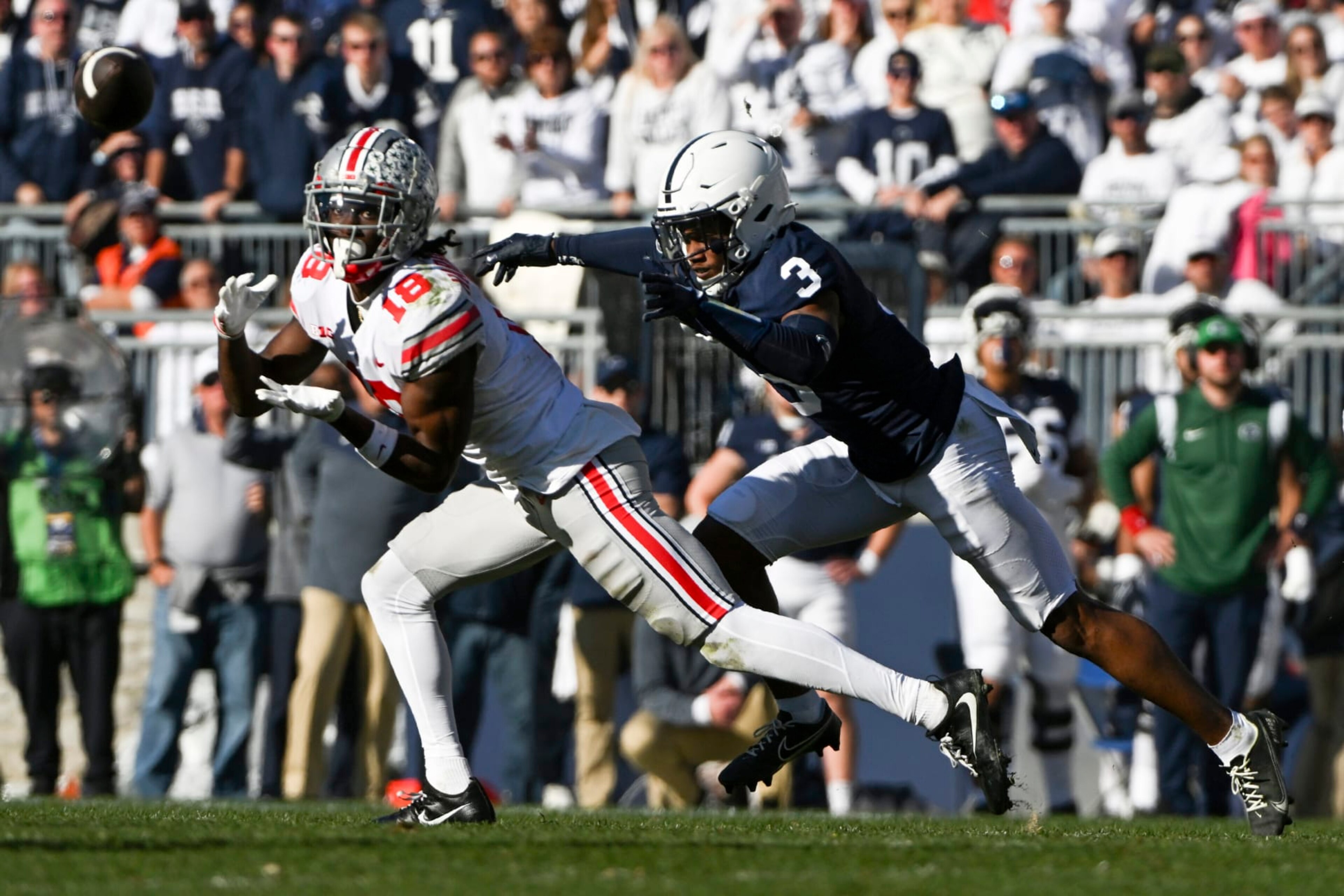 Ohio State wide receiver Marvin Harrison Jr. (18) makes a catch in front of Penn State cornerback Johnny Dixon (3) during the second half of an NCAA college football game, Saturday, Oct. 29, 2022, in State College, Pa. (AP Photo/Barry Reeger) Ohio State wide receiver Marvin Harrison Jr. (18) makes a catch in front of Penn State cornerback Johnny Dixon (3) during the second half of an NCAA college football game, Saturday, Oct. 29, 2022, in State College, Pa. (AP Photo/Barry Reeger)