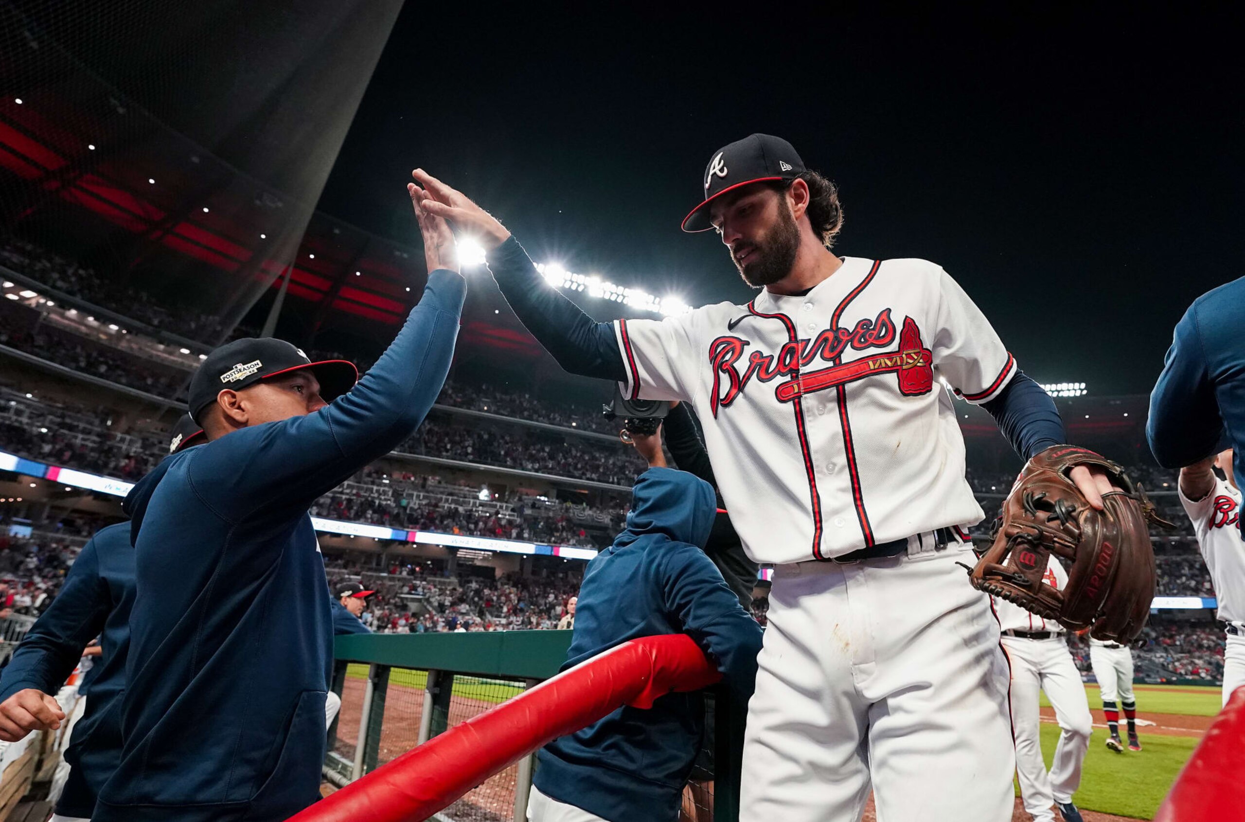 ATLANTA, GA - OCTOBER 12: Dansby Swanson #7 of the Atlanta Braves is congratulated teammates after making a diving catch against the Philadelphia Phillies during the sixth inning in game two of the National League Division Series at Truist Park on October 12, 2022 in Atlanta, Georgia. (Photo by Kevin D. Liles/Atlanta Braves/Getty Images)