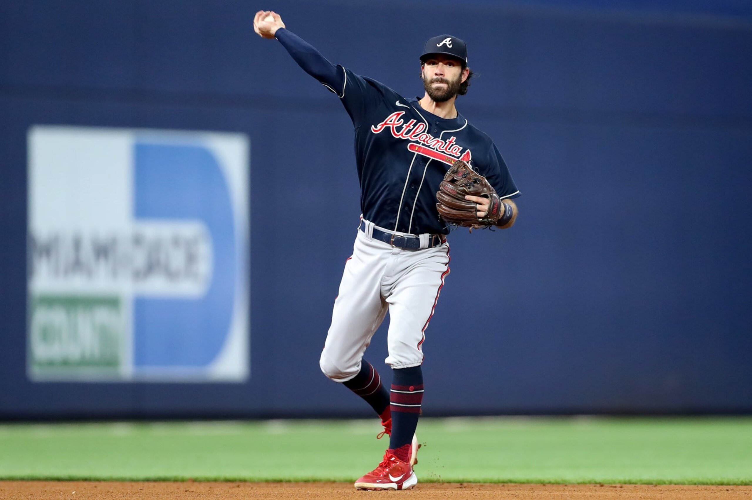 MIAMI, FLORIDA - OCTOBER 03: Dansby Swanson #7 of the Atlanta Braves throws to first base during the fifth inning of the game against the Miami Marlins at loanDepot park on October 03, 2022 in Miami, Florida. (Photo by Megan Briggs/Getty Images)