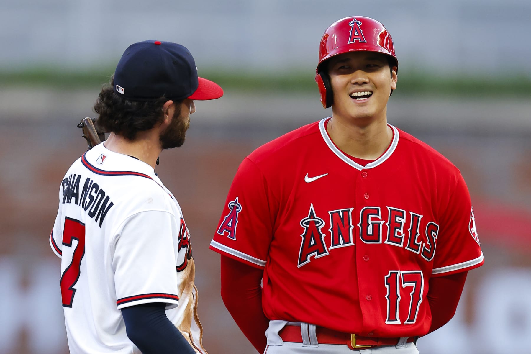 ATLANTA, GA - JULY 23: Shohei Ohtani #17 of the Los Angeles Angels speaks with Dansby Swanson #7 of the Atlanta Braves during the third inning at Truist Park on July 23, 2022 in Atlanta, Georgia. (Photo by Todd Kirkland/Getty Images)