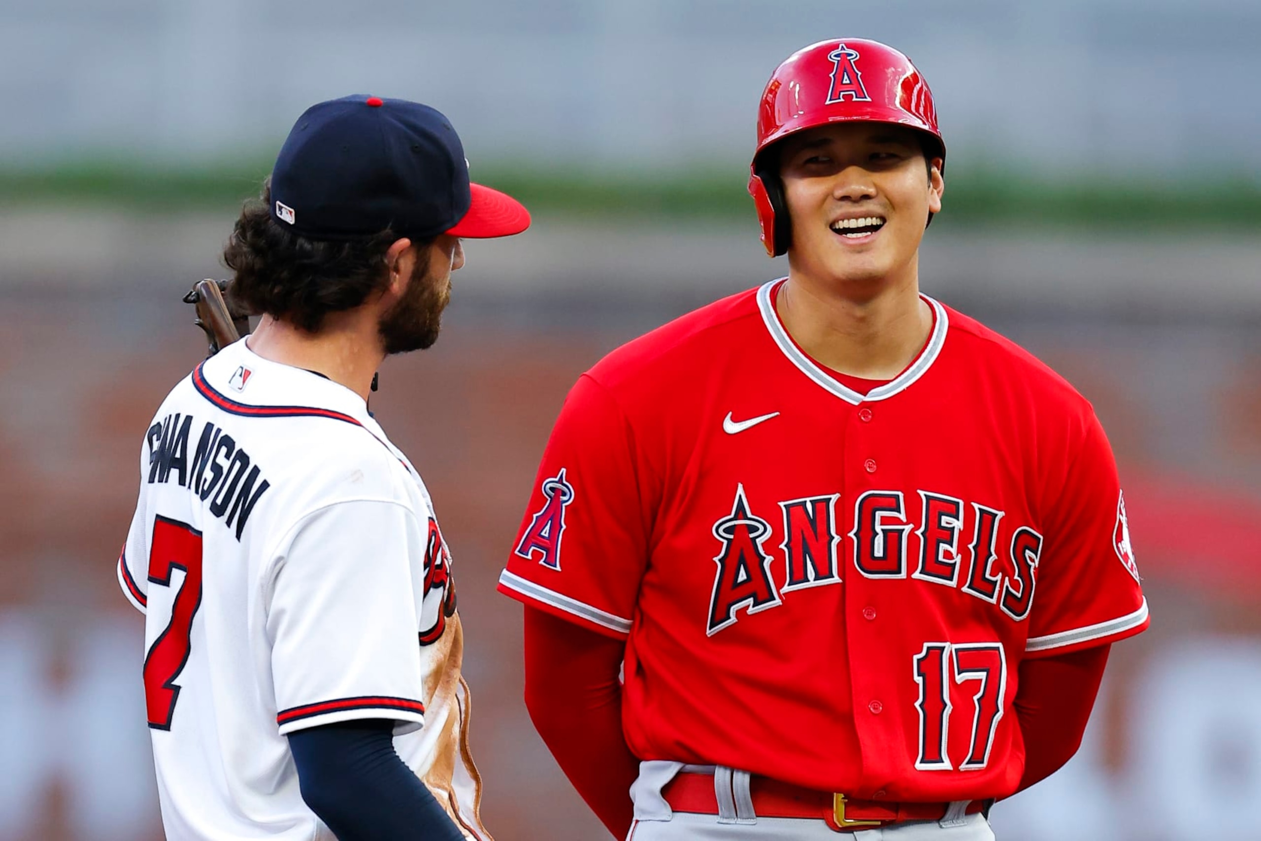 ATLANTA, GA - JULY 23: Shohei Ohtani #17 of the Los Angeles Angels speaks with Dansby Swanson #7 of the Atlanta Braves during the third inning at Truist Park on July 23, 2022 in Atlanta, Georgia. (Photo by Todd Kirkland/Getty Images)