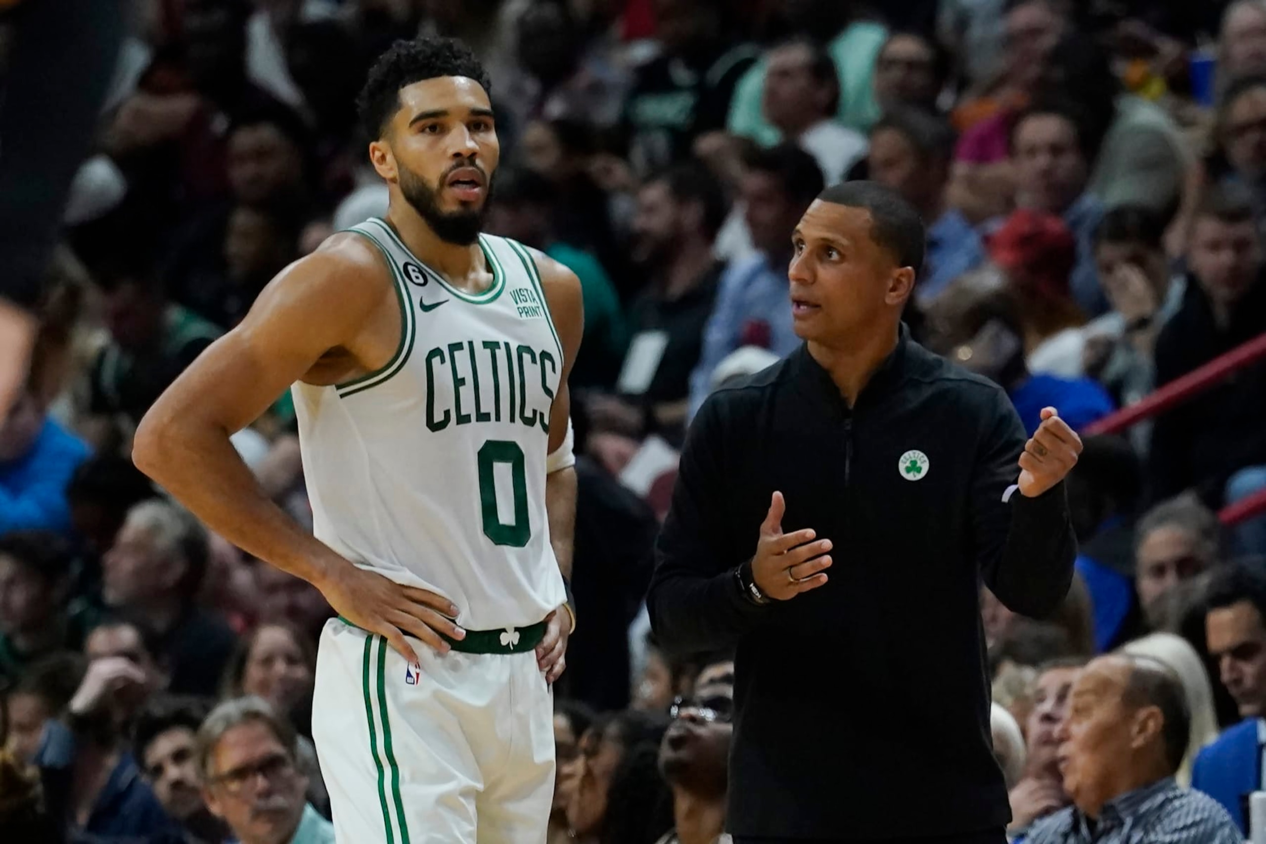 Boston Celtics forward Jayson Tatum (0) listens to head coach Joe Mazzulla during the second half of an NBA game against the Miami Heat, Friday, Oct. 21, 2022, in Miami. (AP Photo/Marta Lavandier)