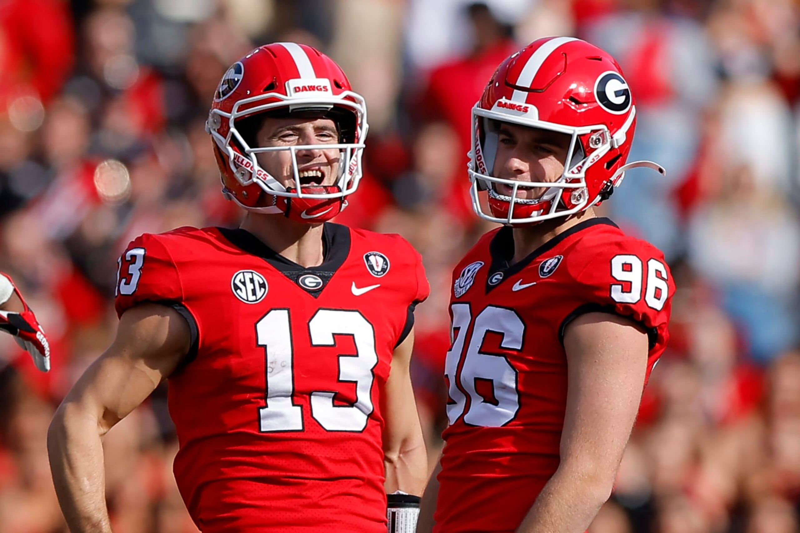 ATHENS, GA - NOVEMBER 26: Stetson Bennett #13 reacts with Jack Podlesny #96 of the Georgia Bulldogs in the second half against the Georgia Tech Yellow Jackets at Sanford Stadium on November 26, 2022 in Athens, Georgia. (Photo by Todd Kirkland/Getty Images)