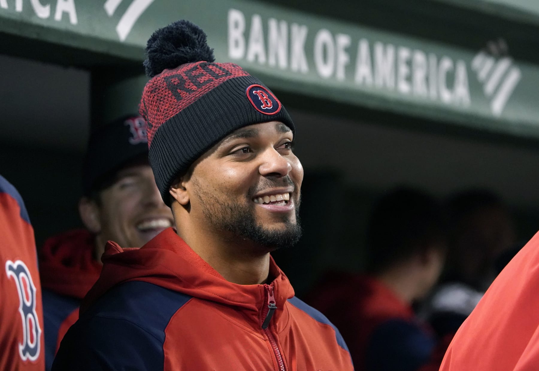 Boston Red Sox's Xander Bogaerts wears a winter hat as he looks on from the dugout during the ninth inning of a baseball game against the Tampa Bay Rays at Fenway Park, Monday, Oct. 3, 2022, in Boston. (AP Photo/Mary Schwalm)