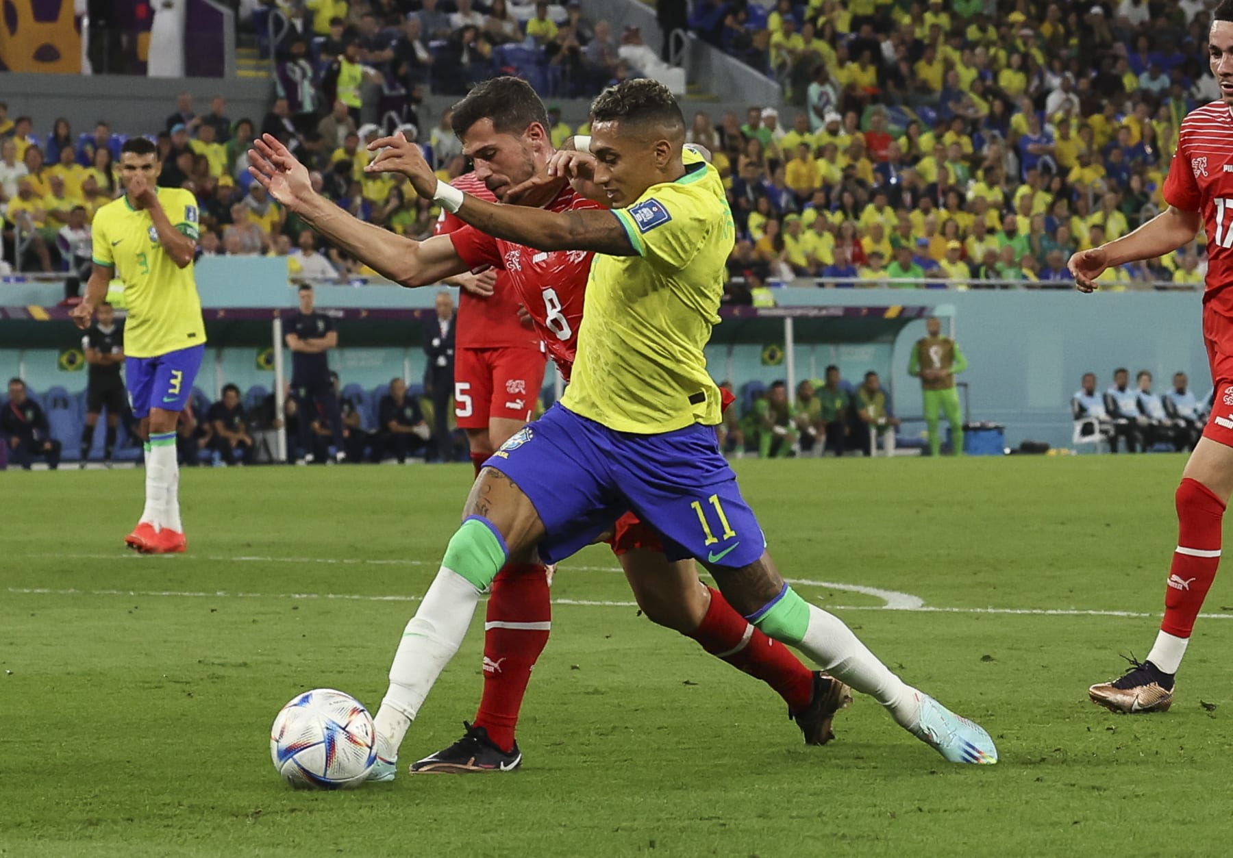 DOHA, QATAR - NOVEMBER 28: Raphinha of Brazil vies with Remo Freuler of Switzerland during the FIFA World Cup Qatar 2022 Group G match between Brazil and Switzerland at Stadium 974 on November 28, 2022 in Doha, Qatar. (Photo by Ian MacNicol/Getty Images)