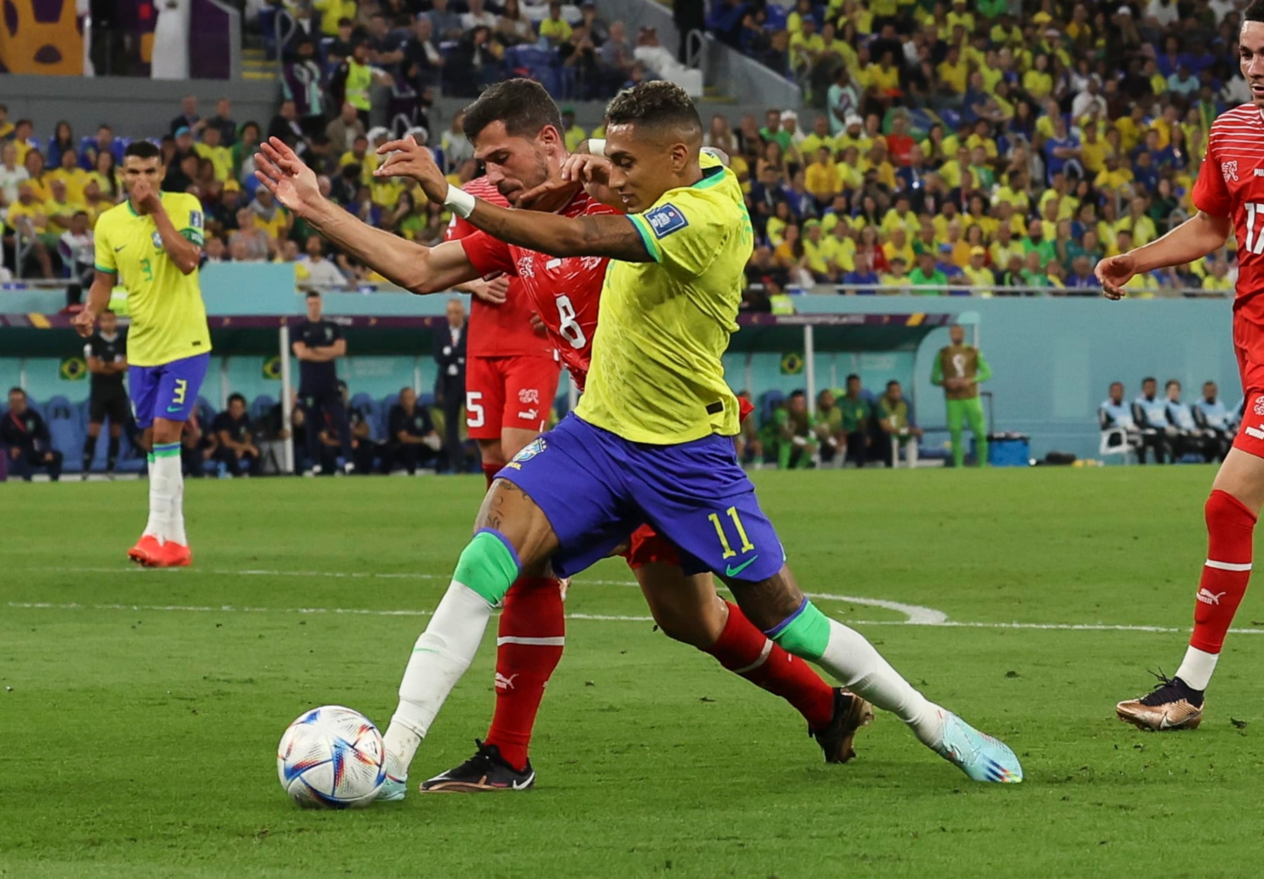 DOHA, QATAR - NOVEMBER 28: Raphinha of Brazil vies with Remo Freuler of Switzerland during the FIFA World Cup Qatar 2022 Group G match between Brazil and Switzerland at Stadium 974 on November 28, 2022 in Doha, Qatar. (Photo by Ian MacNicol/Getty Images)