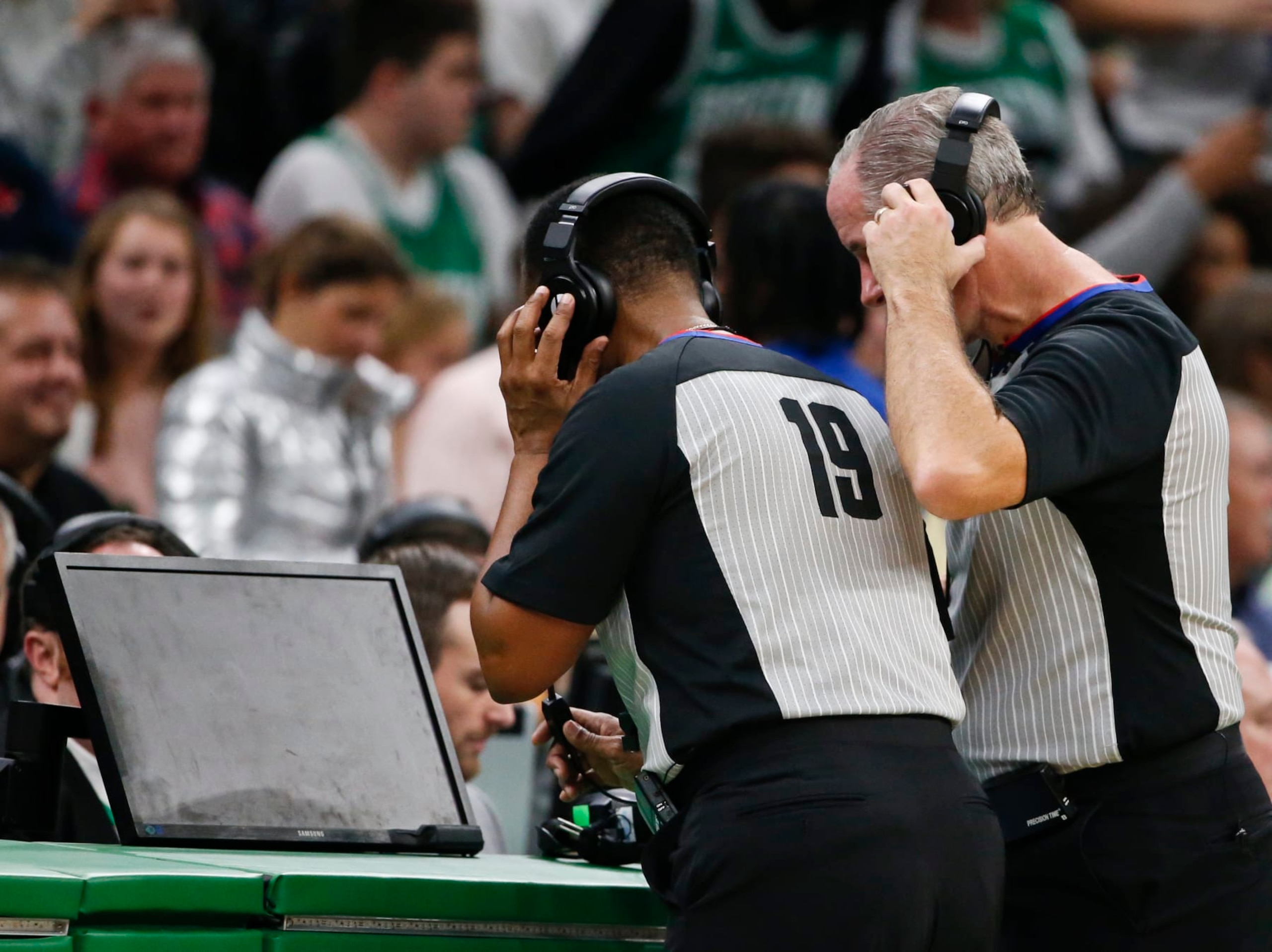 BOSTON - NOVEMBER 27: NBA referees James Capers (19) and Scott Wall look at the replay screen on a blocking call against the Boston Celtics' Jaylen Brown on Brooklyn Nets' Nicolas Claxton during the fourth quarter. After official review, the call was overturned, and Claxton was called for an offensive foul. The Boston Celtics host the Brooklyn Nets in a regular season NBA basketball game at TD Garden in Boston on Nov. 27, 2019. (Photo by Matthew J. Lee/The Boston Globe via Getty Images) BOSTON - NOVEMBER 27: NBA referees James Capers (19) and Scott Wall look at the replay screen on a blocking call against the Boston Celtics' Jaylen Brown on Brooklyn Nets' Nicolas Claxton during the fourth quarter. After official review, the call was overturned, and Claxton was called for an offensive foul. The Boston Celtics host the Brooklyn Nets in a regular season NBA basketball game at TD Garden in Boston on Nov. 27, 2019. (Photo by Matthew J. Lee/The Boston Globe via Getty Images)