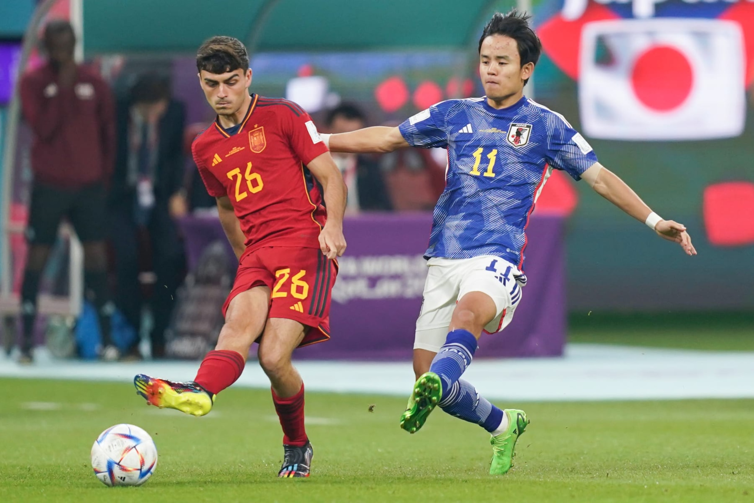 DOHA, QATAR - DECEMBER 01: Pedri (L) of Spain fights for the ball with Takefusa Kubo (R) of Japan during the FIFA World Cup Qatar 2022 Group E match between Japan and Spain at Khalifa International Stadium on December 1, 2022 in Doha, Qatar. (Photo by Khalil Bashar/Jam Media/Getty Images)
