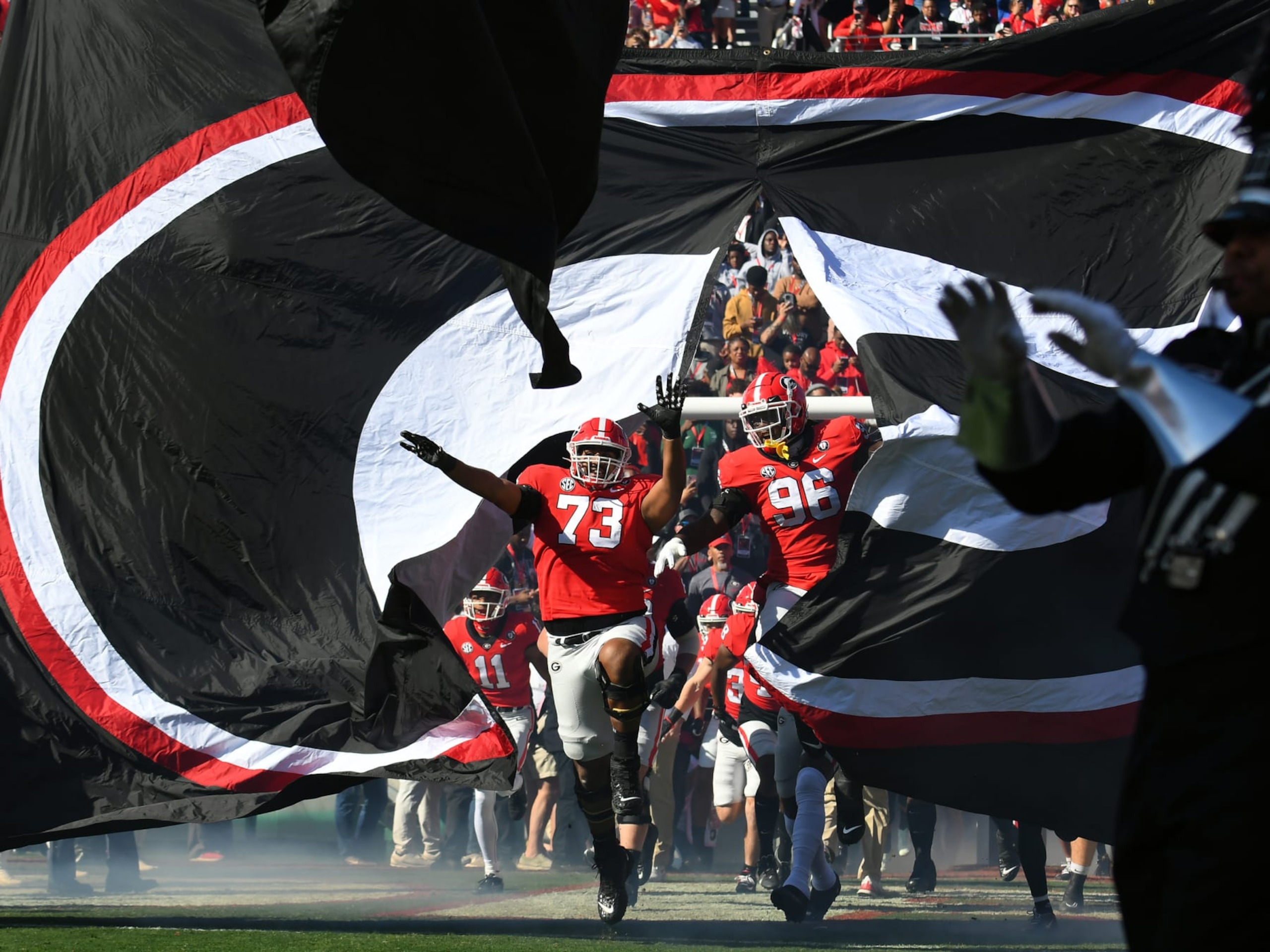ATHENS, GA - NOVEMBER 26: Georgia Bulldogs Offensive Linemen Xavier Truss (73) and Georgia Bulldogs Defensive Linemen Zion Logue (96) lead the the team onto the field before the college football game between the Georgia Tech Yellow Jackets and the Georgia Bulldogs on November 26, 2022, at Sanford Stadium in Athens, GA. (Photo by Jeffrey Vest/Icon Sportswire via Getty Images) ATHENS, GA - NOVEMBER 26: Georgia Bulldogs Offensive Linemen Xavier Truss (73) and Georgia Bulldogs Defensive Linemen Zion Logue (96) lead the the team onto the field before the college football game between the Georgia Tech Yellow Jackets and the Georgia Bulldogs on November 26, 2022, at Sanford Stadium in Athens, GA. (Photo by Jeffrey Vest/Icon Sportswire via Getty Images)
