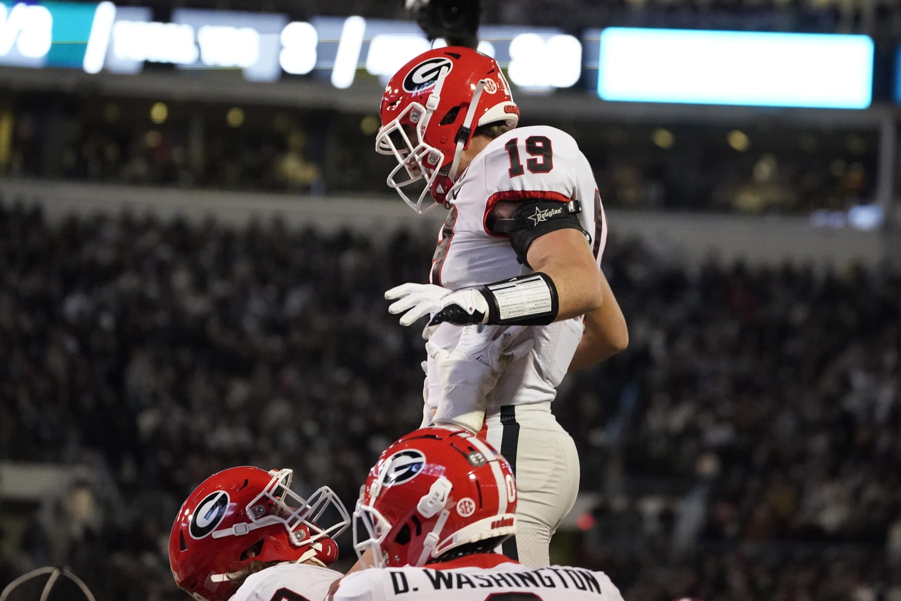 Georgia tight end Brock Bowers (19) is lifted by a teammate after scoring on a two-yard touchdown pass reception during the first half of an NCAA college football game against Mississippi State in Starkville, Miss., Saturday, Nov. 12, 2022. (AP Photo/Rogelio V. Solis)