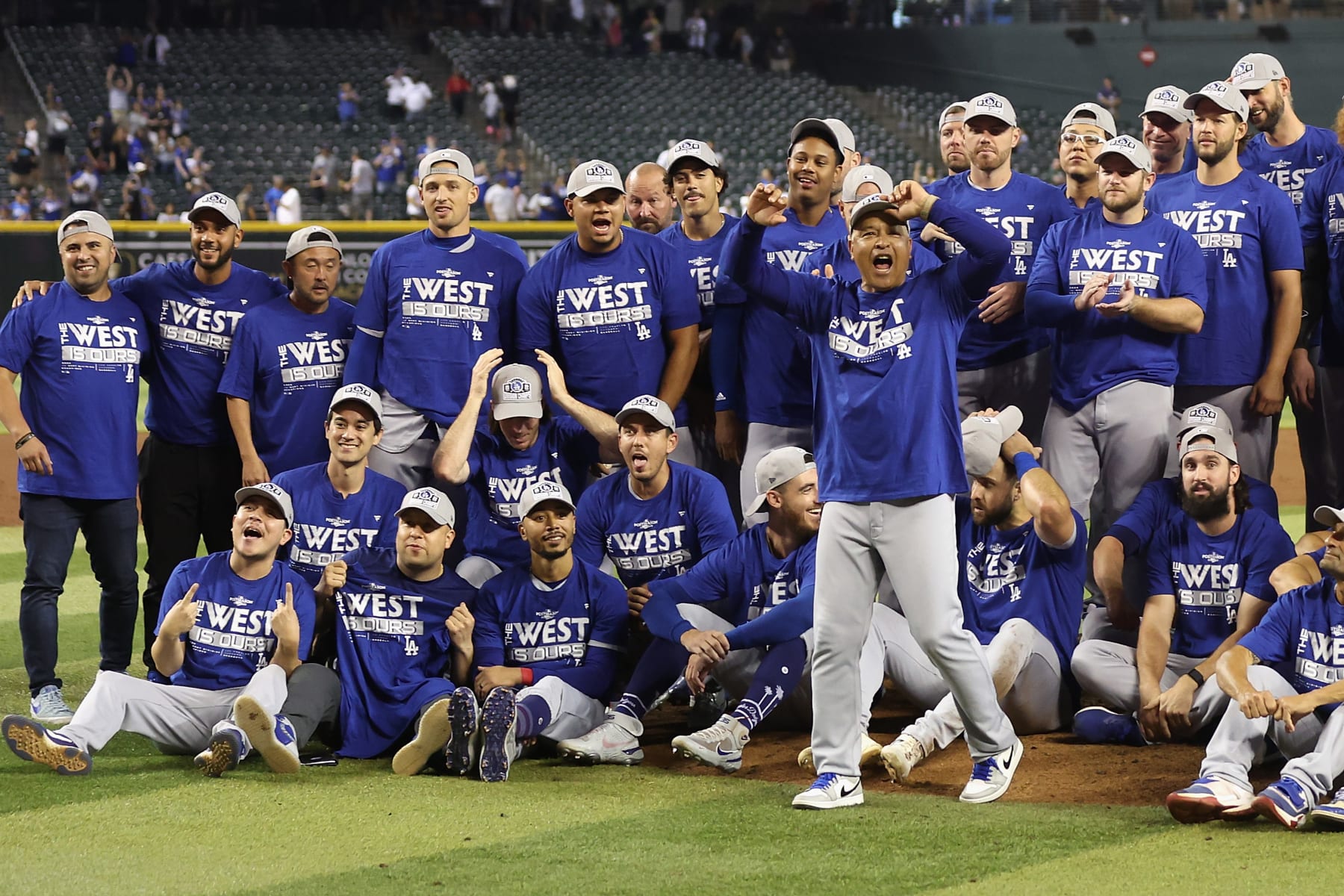 PHOENIX, ARIZONA - SEPTEMBER 13: Manager Dave Roberts #30 of the Los Angeles Dodgers celebrates with teammates after defeating the Arizona Diamondbacks at Chase Field on September 13, 2022 in Phoenix, Arizona. The Dodgers defeated the Diamondbacks 4-0 to clinch the National League West division. ˆ (Photo by Christian Petersen/Getty Images)