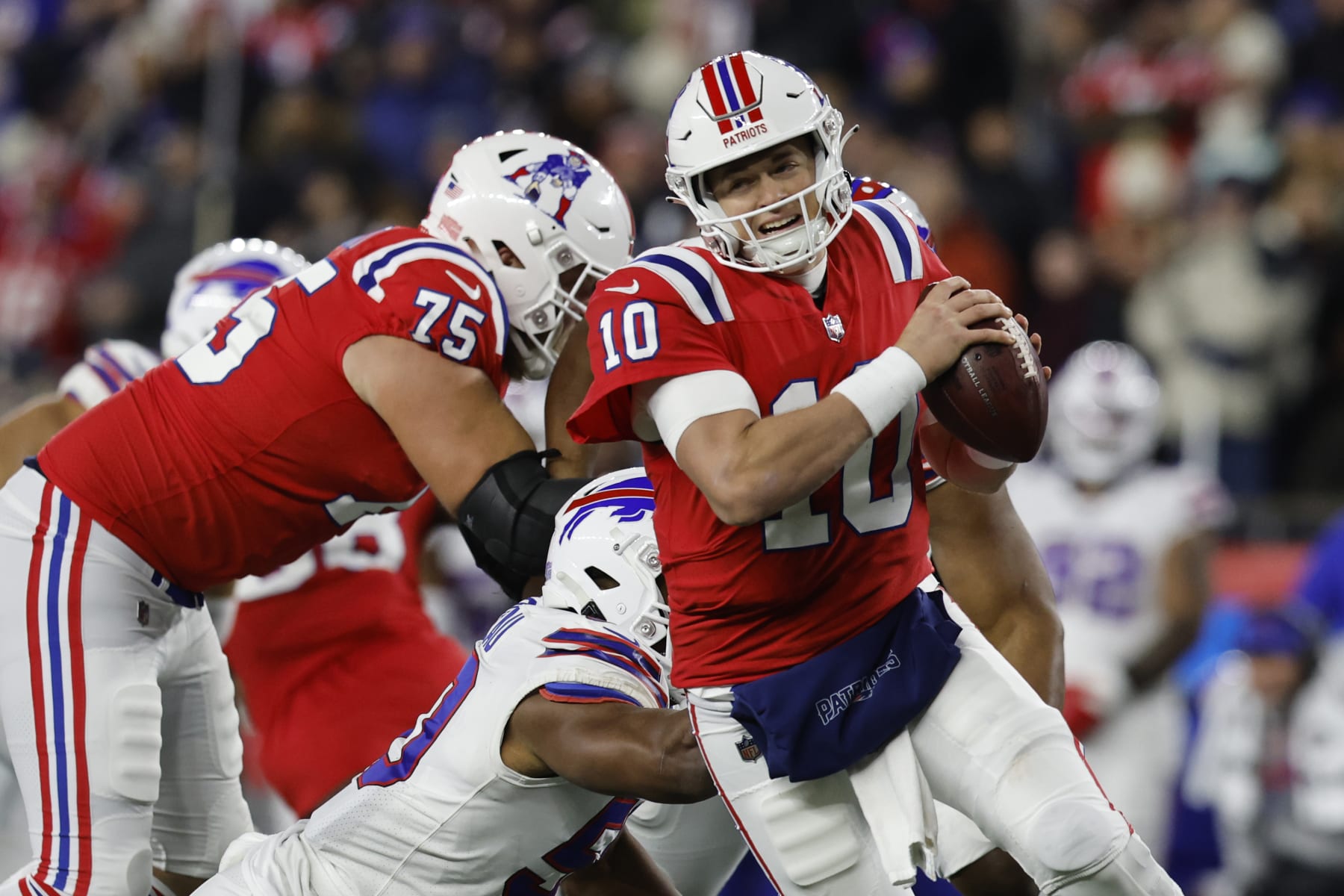 New England Patriots quarterback Mac Jones (10) scrambles during the first half of an NFL football game, Thursday, Dec. 1, 2022, in Foxborough, Mass. (AP Photo/Michael Dwyer)