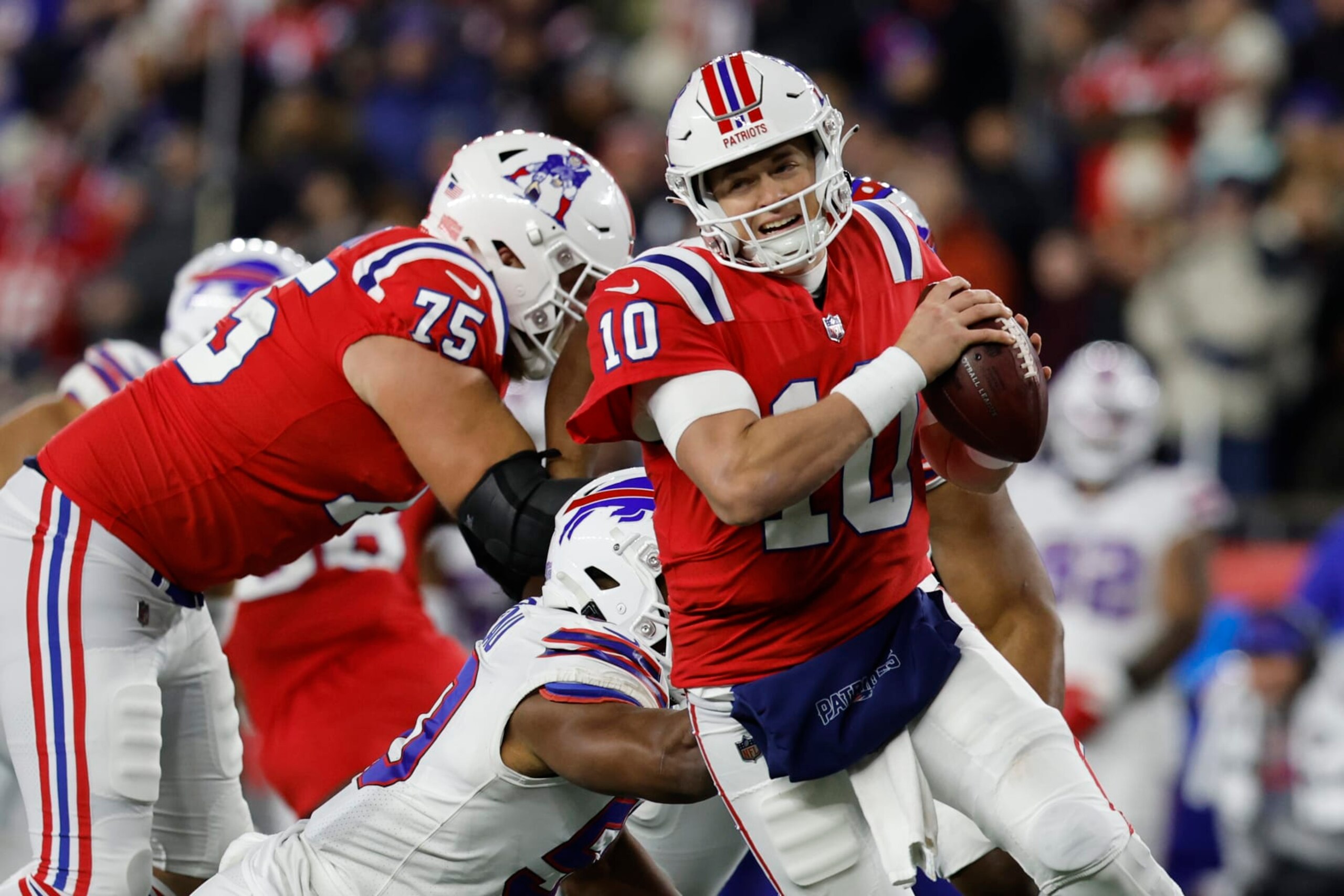 New England Patriots quarterback Mac Jones (10) scrambles during the first half of an NFL football game, Thursday, Dec. 1, 2022, in Foxborough, Mass. (AP Photo/Michael Dwyer)