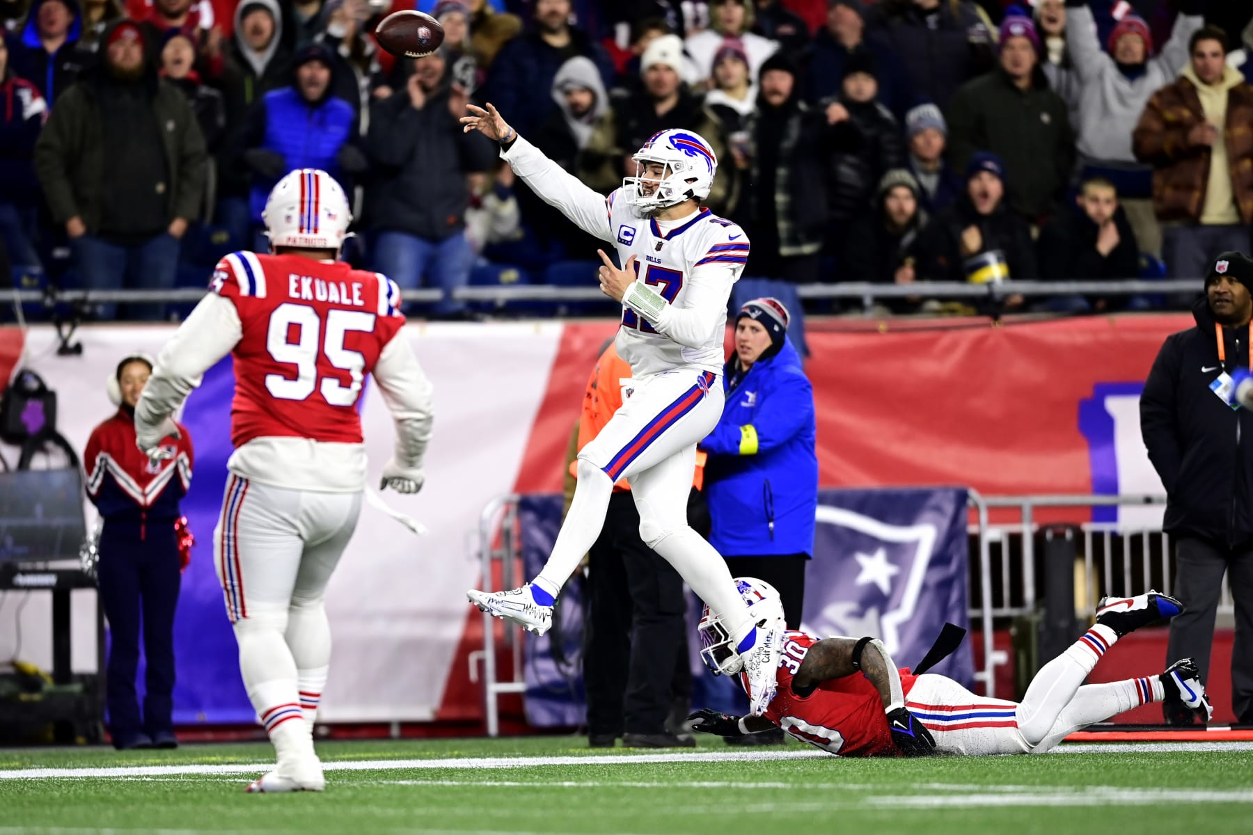 FOXBOROUGH, MASSACHUSETTS - DECEMBER 01: Quarterback Josh Allen #17 of the Buffalo Bills throws a second quarter touchdown pass in front of linebacker Mack Wilson Sr. #30 of the New England Patriots at Gillette Stadium on December 01, 2022 in Foxborough, Massachusetts. (Photo by Billie Weiss/Getty Images)