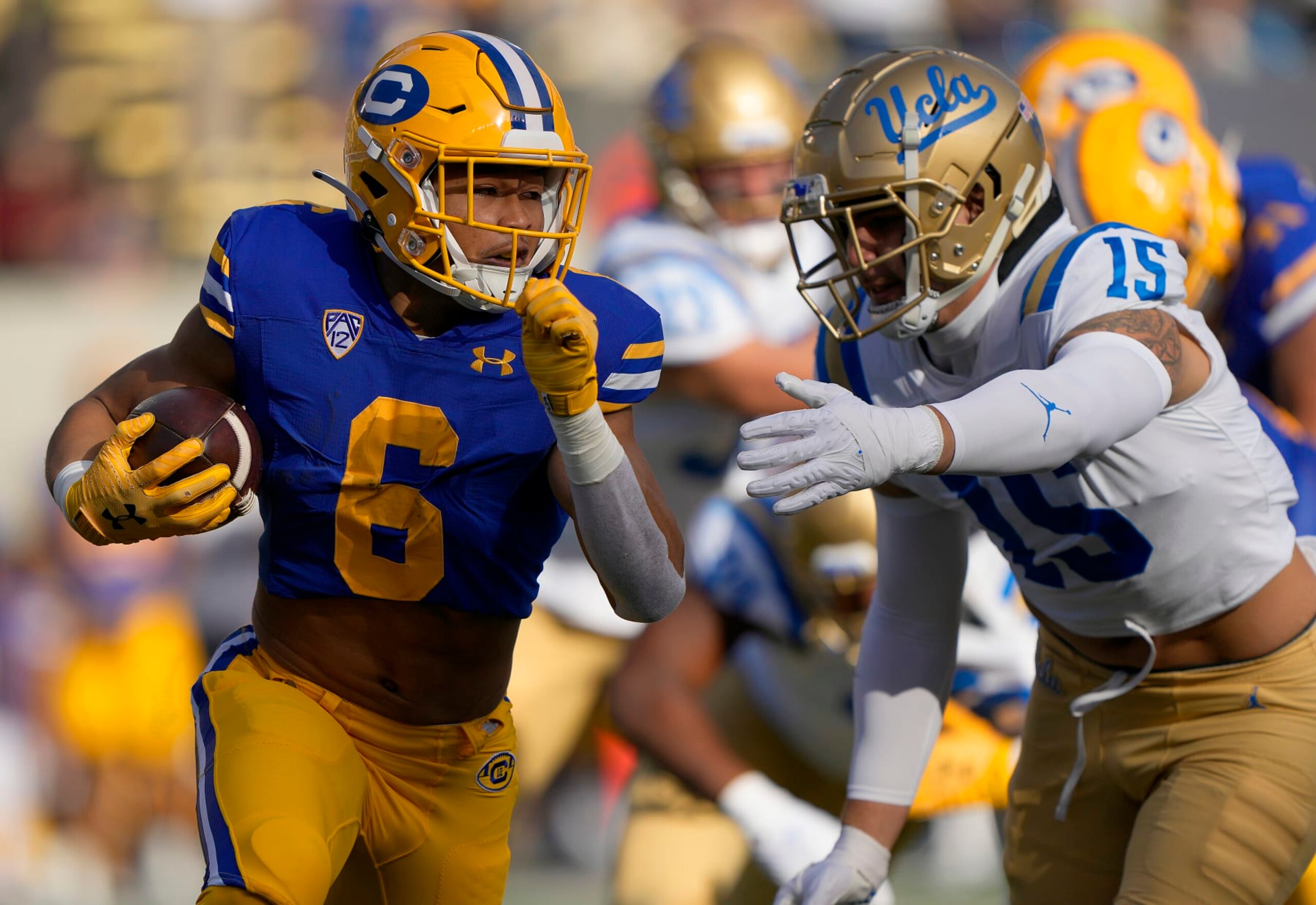 BERKELEY, CALIFORNIA - NOVEMBER 25: Jaydn Ott #6 of the California Golden Bears rushing with the ball runs out of the tackle of Laiatu Latu #15 of the UCLA Bruins during the first quarter of an NCAA football game at California Memorial Stadium on November 25, 2022 in Berkeley, California. (Photo by Thearon W. Henderson/Getty Images)
