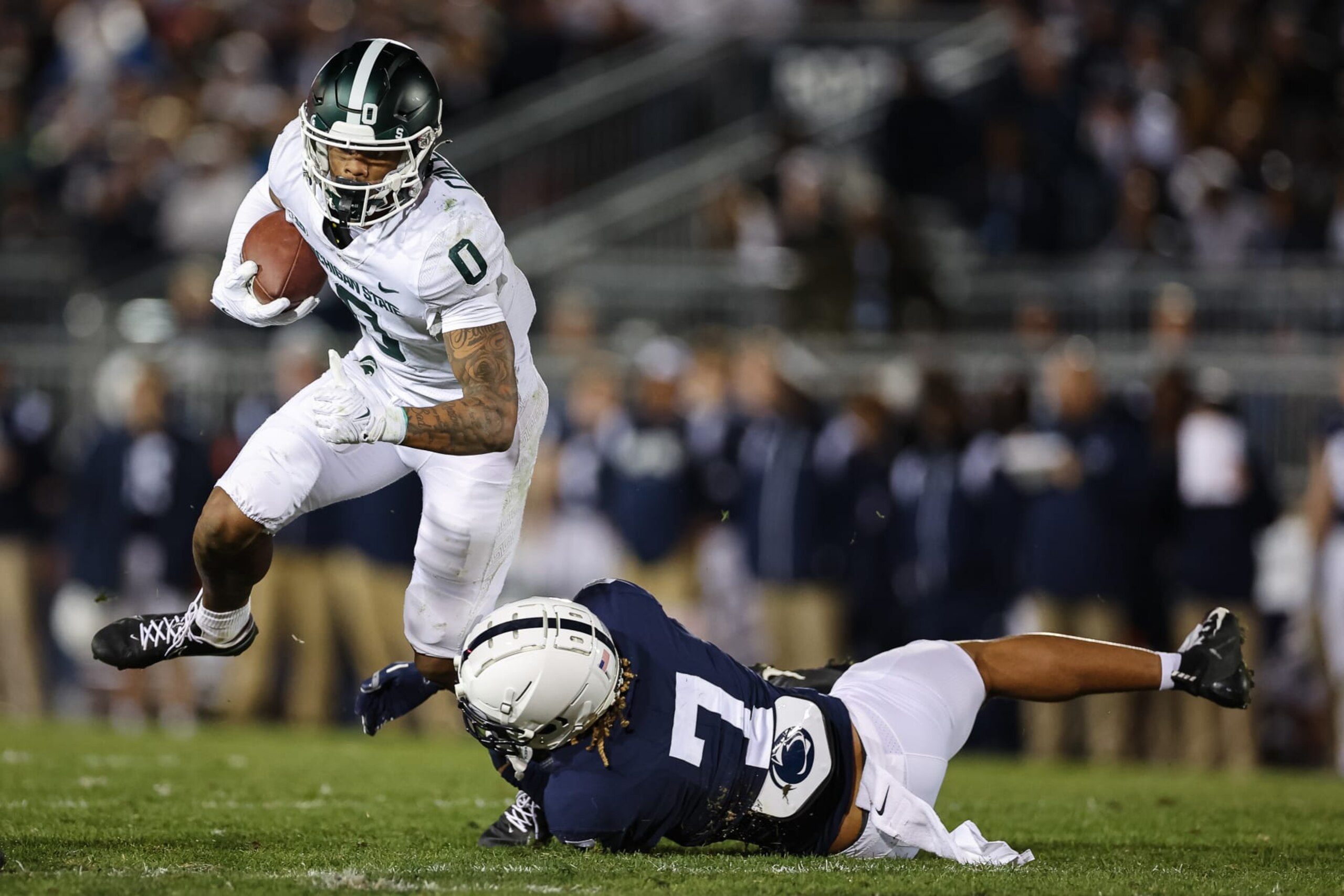 STATE COLLEGE, PA - NOVEMBER 26: Keon Coleman #0 of the Michigan State Spartans carries the ball as Aaron Brule #7 of the Michigan State Spartans defends during the second half at Beaver Stadium on November 26, 2022 in State College, Pennsylvania. (Photo by Scott Taetsch/Getty Images)