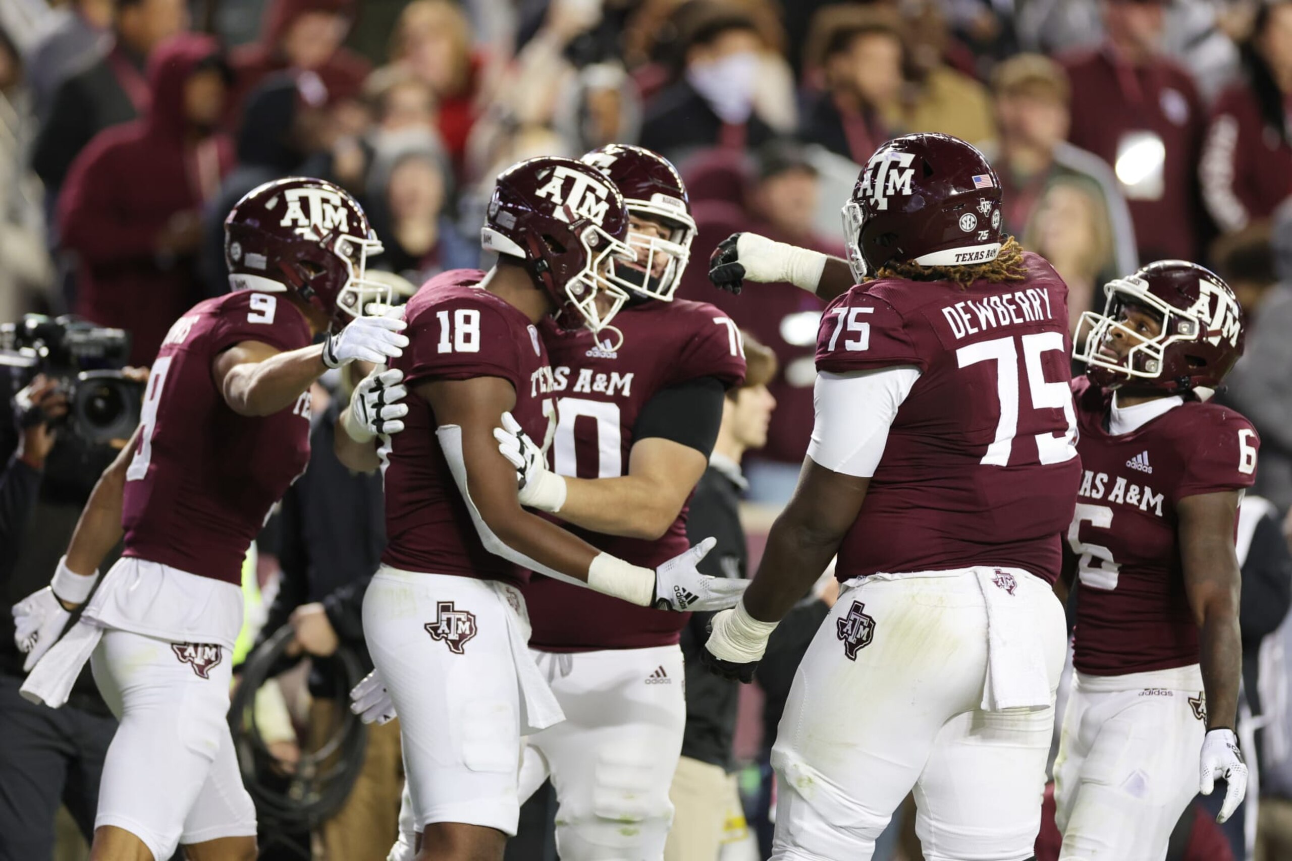 COLLEGE STATION, TEXAS - NOVEMBER 26: Donovan Green #18  celebrates his touchdown with Evan Stewart #1, Noah Thomas #9, and Kam Dewberry #75 of the Texas A&M Aggies during the first half against the LSU Tigers at Kyle Field on November 26, 2022 in College Station, Texas. (Photo by Carmen Mandato/Getty Images)