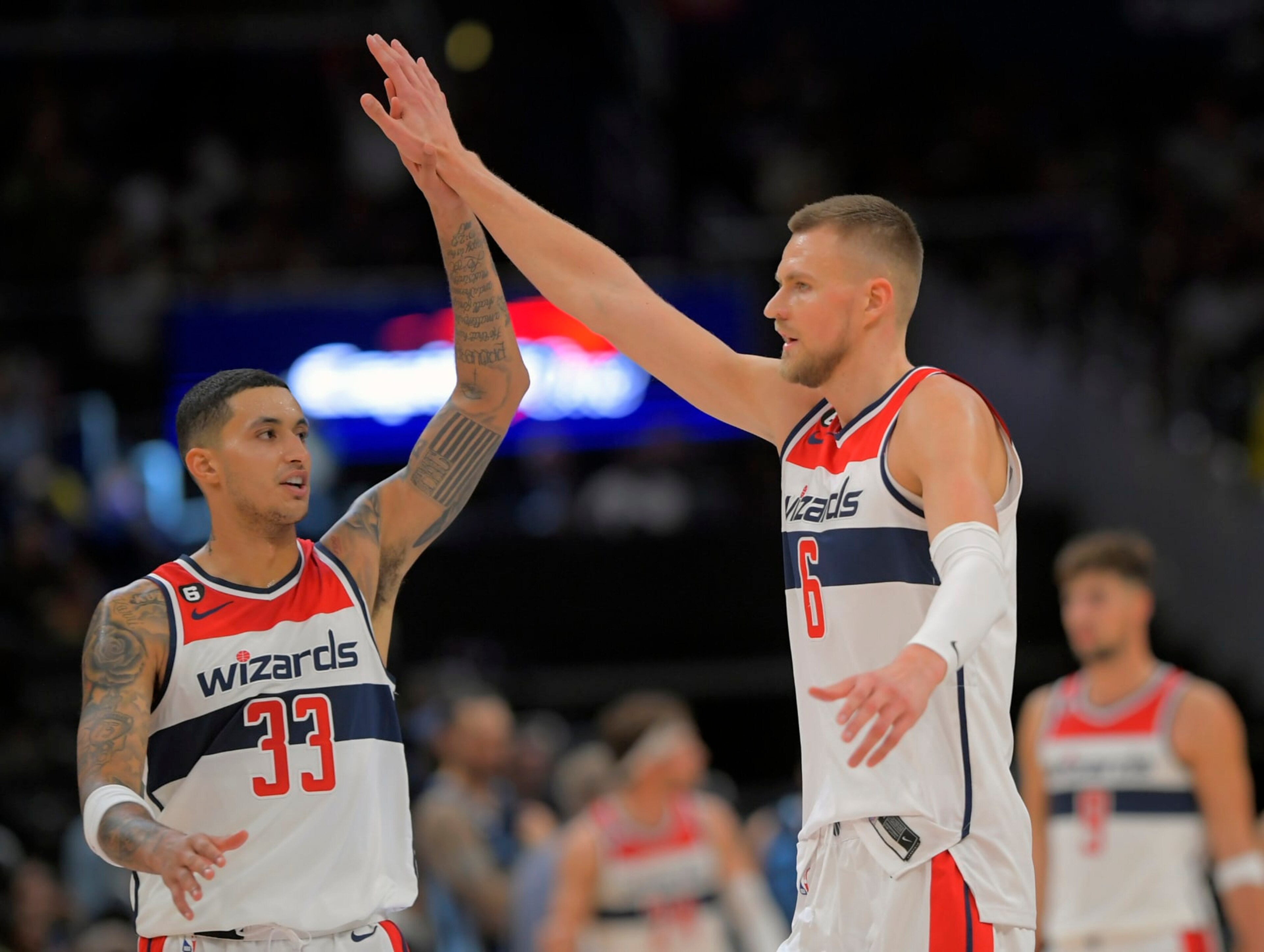 WASHINGTON, DC - NOVEMBER 13:  Washington Wizards forward Kyle Kuzma (33),, left, congratulates Washington Wizards center Kristaps Porzingis (6) after hitting a 3 pointer during the Washington Wizards defeat of the Memphis Grizzlies102-92 at the Capital One Arena on November 13, 2022 in Washington, DC. (Photo by John McDonnell/The Washington Post via Getty Images)