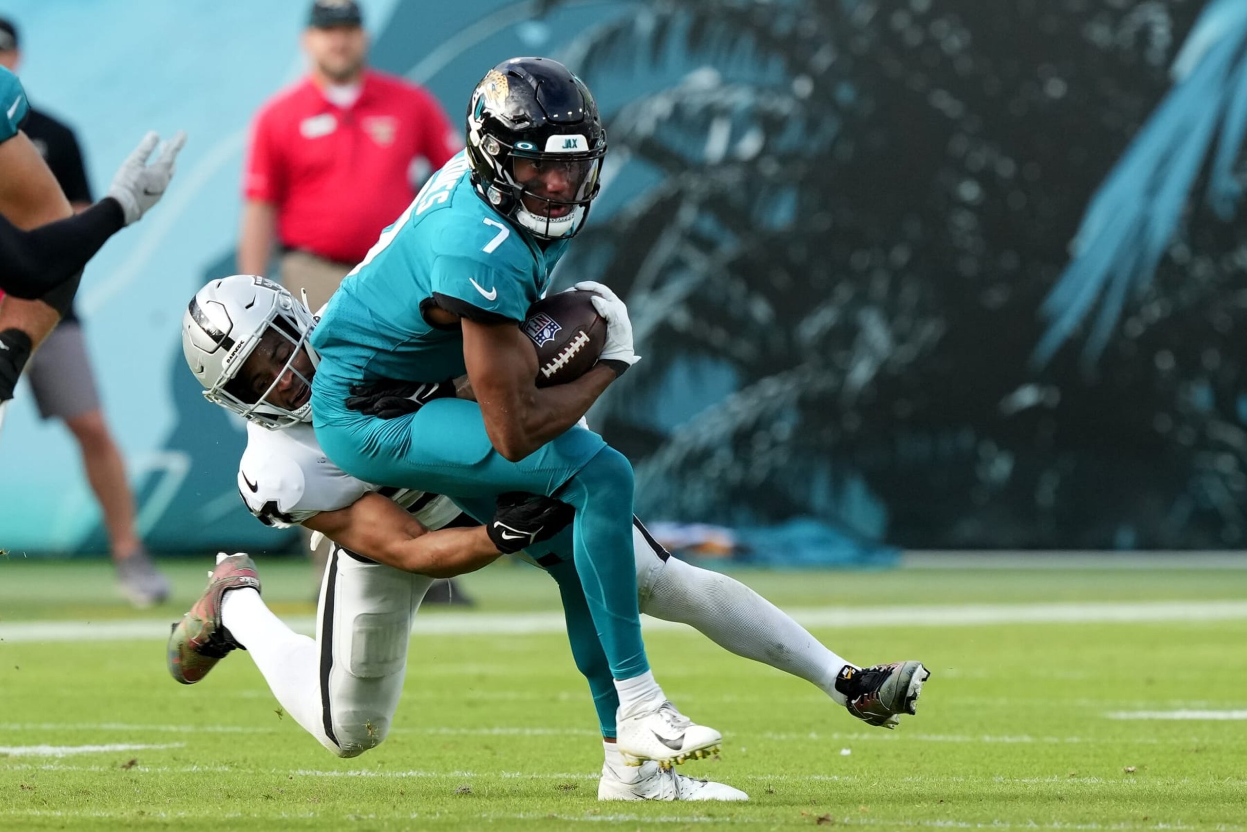 JACKSONVILLE, FLORIDA - NOVEMBER 06: Zay Jones #7 of the Jacksonville Jaguars is tackled by Johnathan Abram #24 of the Las Vegas Raiders during the second half of the game at TIAA Bank Field on November 06, 2022 in Jacksonville, Florida. (Photo by Eric Espada/Getty Images)