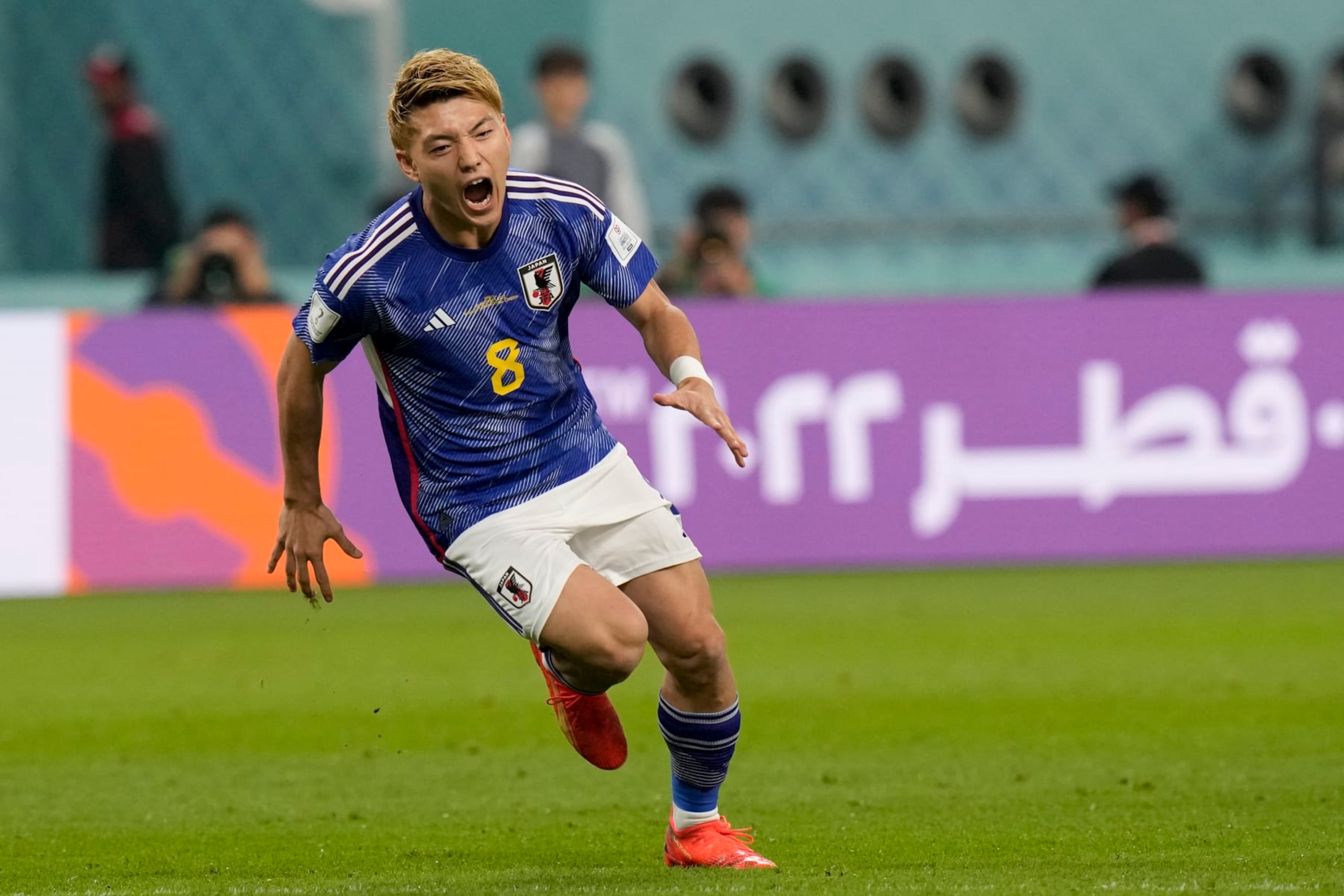 Japan's Ritsu Doan celebrates scoring his side's first goal during a World Cup group E soccer match at the Khalifa International Stadium in Doha, Qatar, Thursday, Dec. 1, 2022. (AP Photo/Eugene Hoshiko)