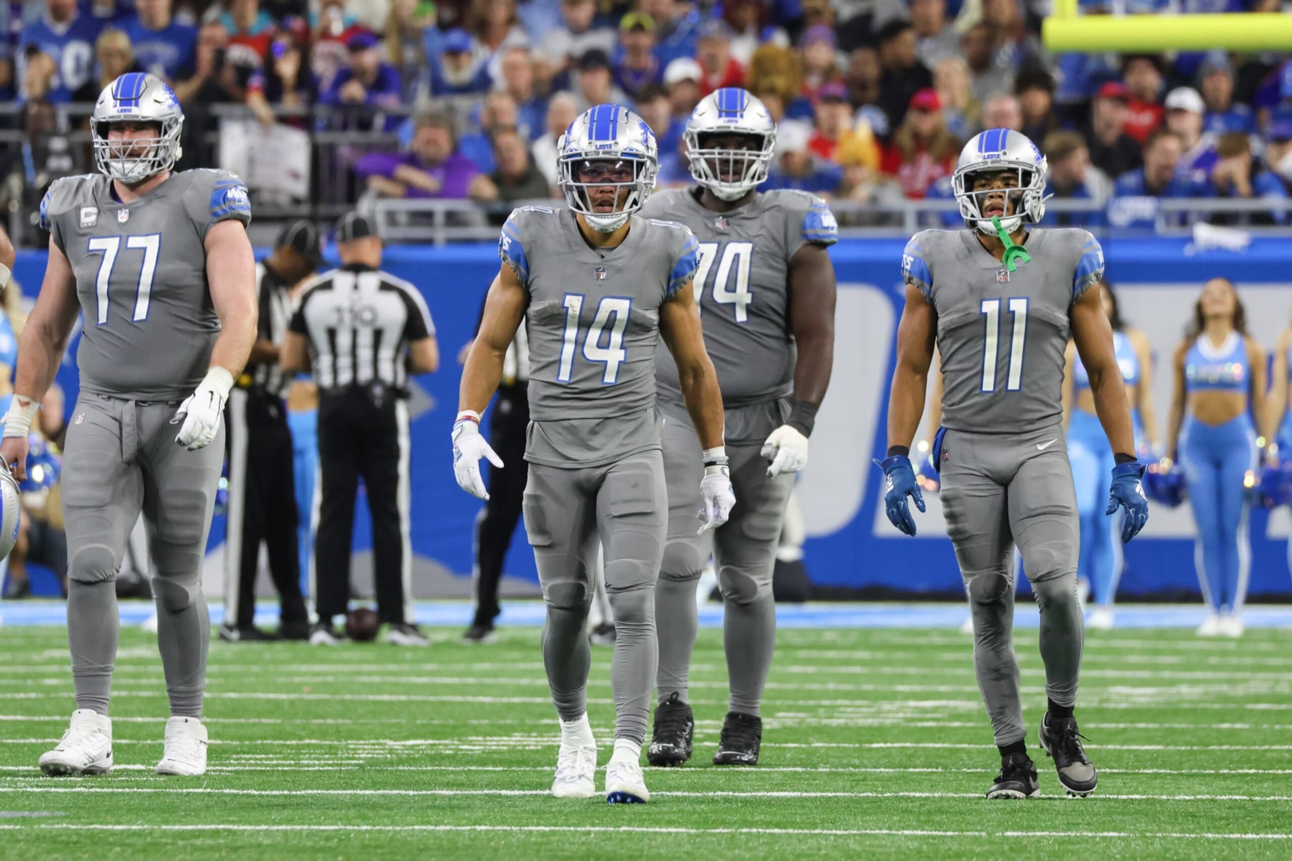 DETROIT, MI - NOVEMBER 24:  Detroit Lions wide receiver Amon-Ra St. Brown (14) along with Detroit Lions center Frank Ragnow (77), Detroit Lions guard Kayode Awosika (74), and Detroit Lions wide receiver Kalif Raymond (11) walk back to the scrimmage line after a stoppage in play during a regular season NFL football game between the Buffalo Bills and the Detroit Lions on Thanksgiving Day on November 24, 2022 at Ford Field in Detroit, Michigan.  (Photo by Scott W. Grau/Icon Sportswire via Getty Images)