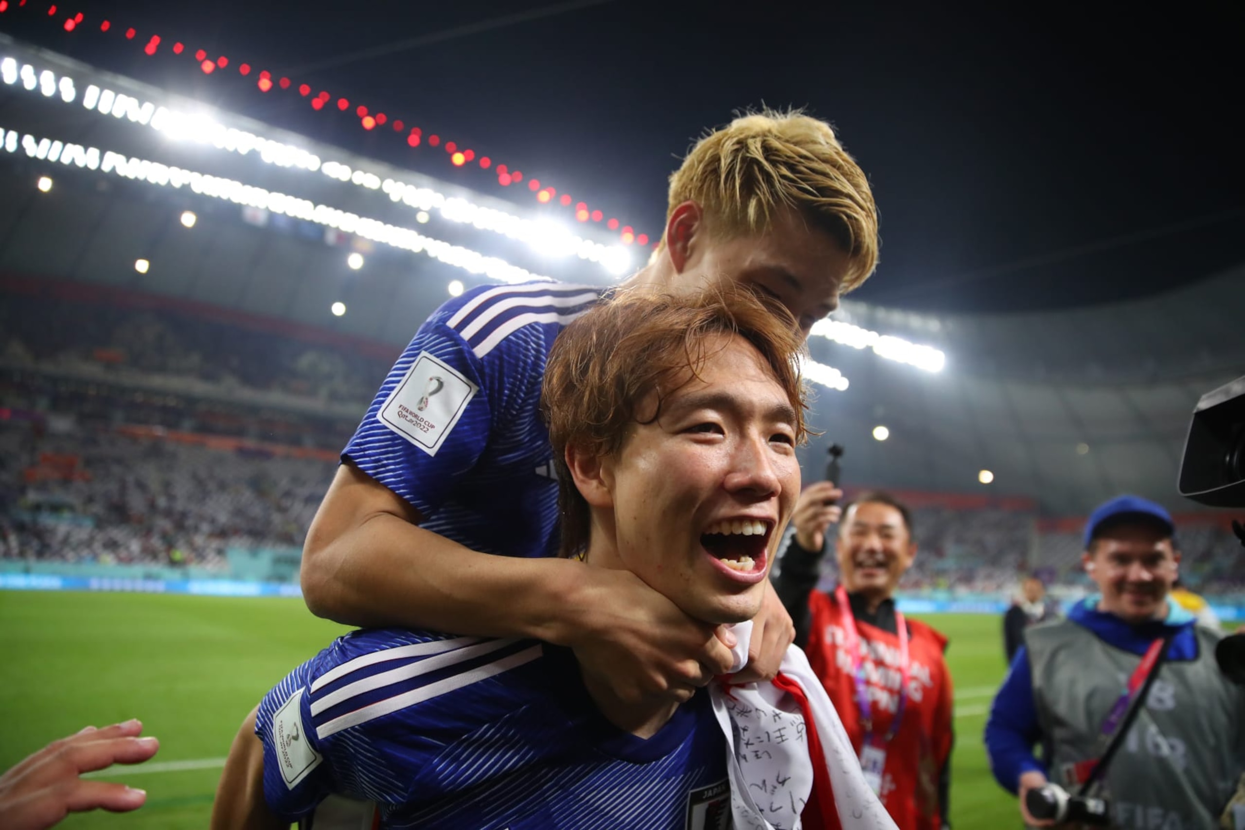 DOHA, QATAR - DECEMBER 01:  Ritsu Doan celebrates with Ko Itakura of Japan after the win seeing them top the group during the FIFA World Cup Qatar 2022 Group E match between Japan and Spain at Khalifa International Stadium on December 1, 2022 in Doha, Qatar. (Photo by Marc Atkins/Getty Images)
