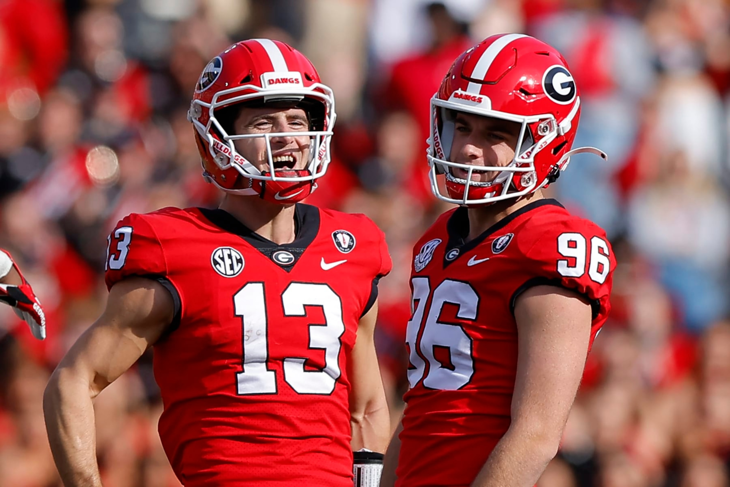 ATHENS, GA - NOVEMBER 26: Stetson Bennett #13 reacts with Jack Podlesny #96 of the Georgia Bulldogs in the second half against the Georgia Tech Yellow Jackets at Sanford Stadium on November 26, 2022 in Athens, Georgia. (Photo by Todd Kirkland/Getty Images)
