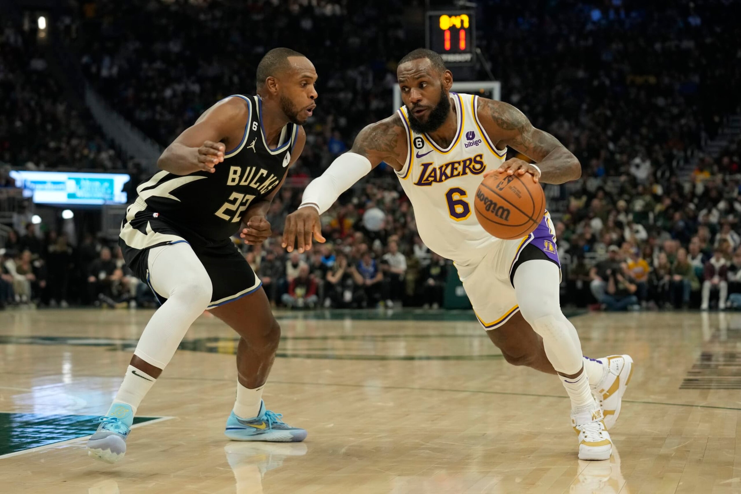 MILWAUKEE, WISCONSIN - DECEMBER 02: LeBron James #6 of the Los Angeles Lakers dribbles the ball against Khris Middleton #22 of the Milwaukee Bucks during the first half of the game at Fiserv Forum on December 02, 2022 in Milwaukee, Wisconsin. NOTE TO USER: User expressly acknowledges and agrees that, by downloading and or using this photograph, User is consenting to the terms and conditions of the Getty Images License Agreement. (Photo by Patrick McDermott/Getty Images)