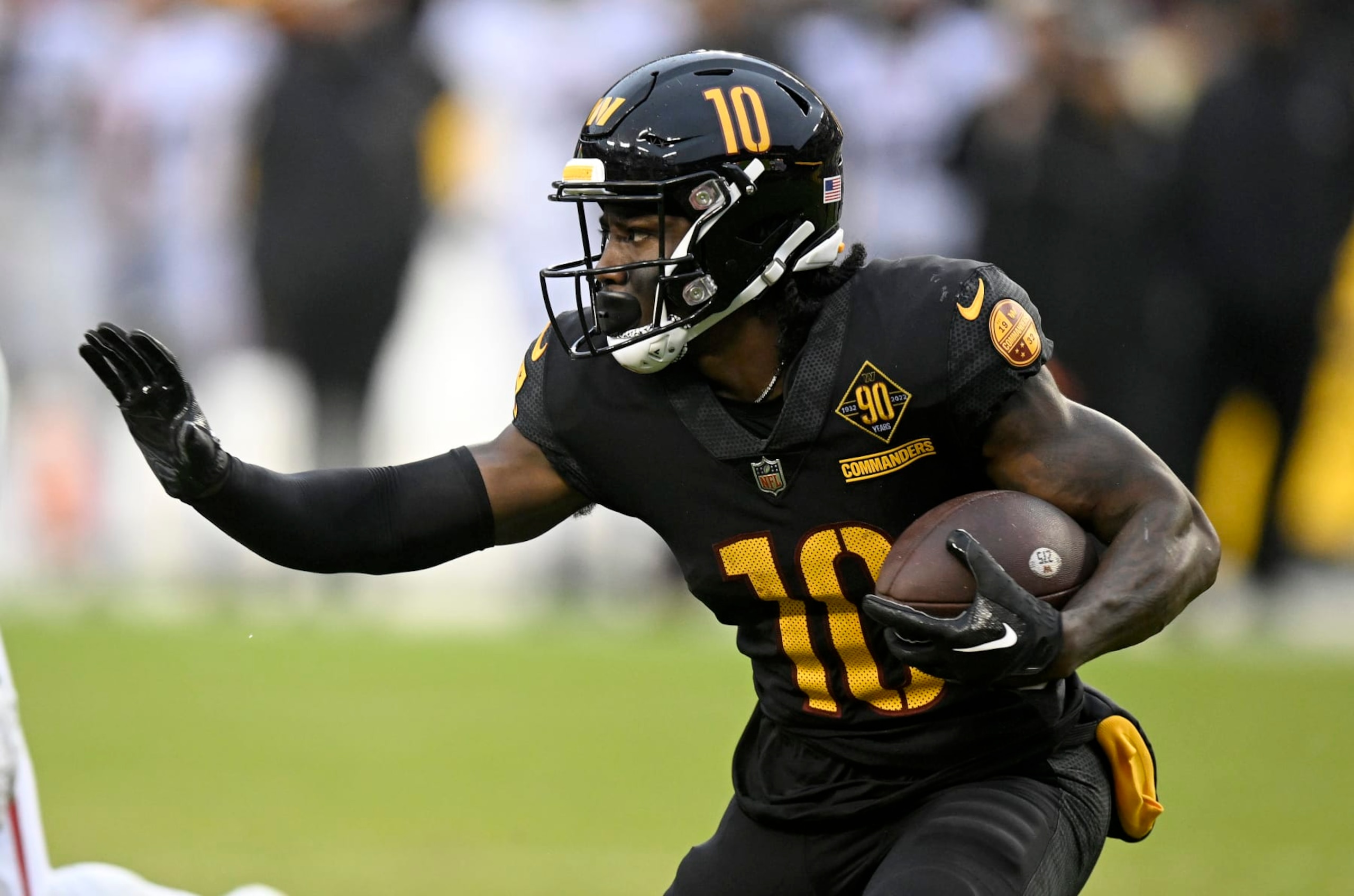 LANDOVER, MARYLAND - NOVEMBER 27: Curtis Samuel #10 of the Washington Commanders rushes the ball against the Atlanta Falcons at FedExField on November 27, 2022 in Landover, Maryland. (Photo by G Fiume/Getty Images)