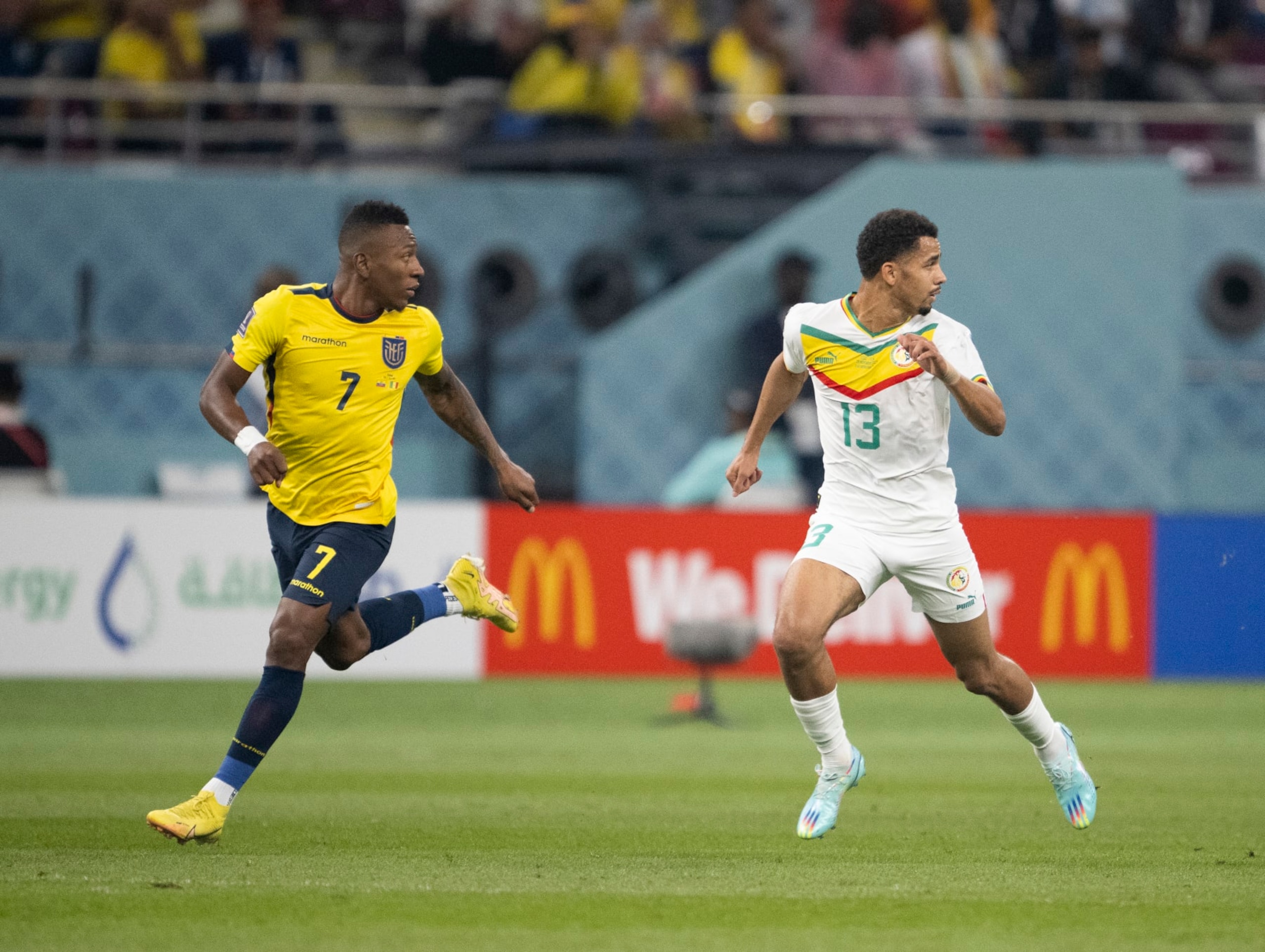 DOHA, QATAR - NOVEMBER 29: Pervis Estupinan of Ecuador and Iliman Ndiaye of Senegal run during the FIFA World Cup Qatar 2022 Group A match between Ecuador and Senegal at Khalifa International Stadium on November 29, 2022 in Doha, Qatar. (Photo by Sebastian Frej/MB Media/Getty Images)
