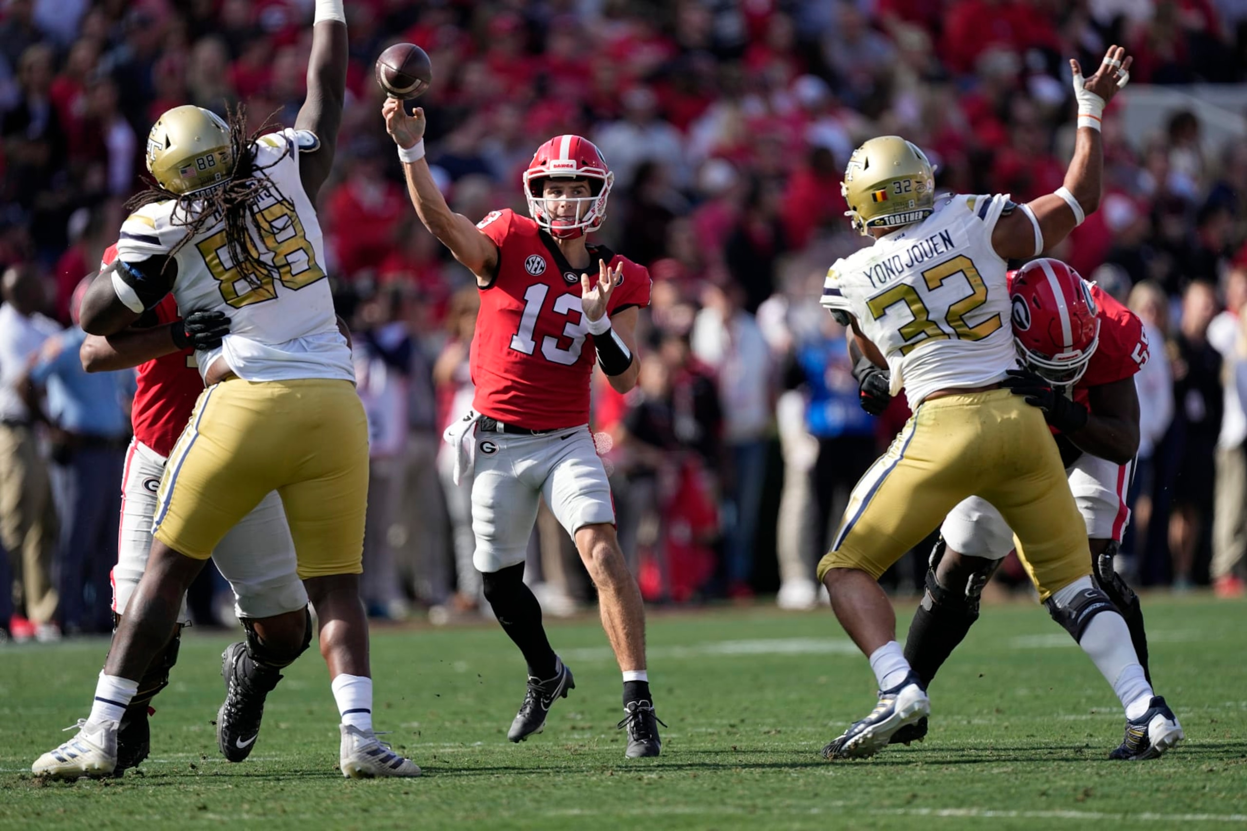 Georgia quarterback Stetson Bennett (13) throws from the pocket during an NCAA college football game against Georgia Tech Saturday, Nov. 26, 2022 in Athens, Ga. (AP Photo/John Bazemore)